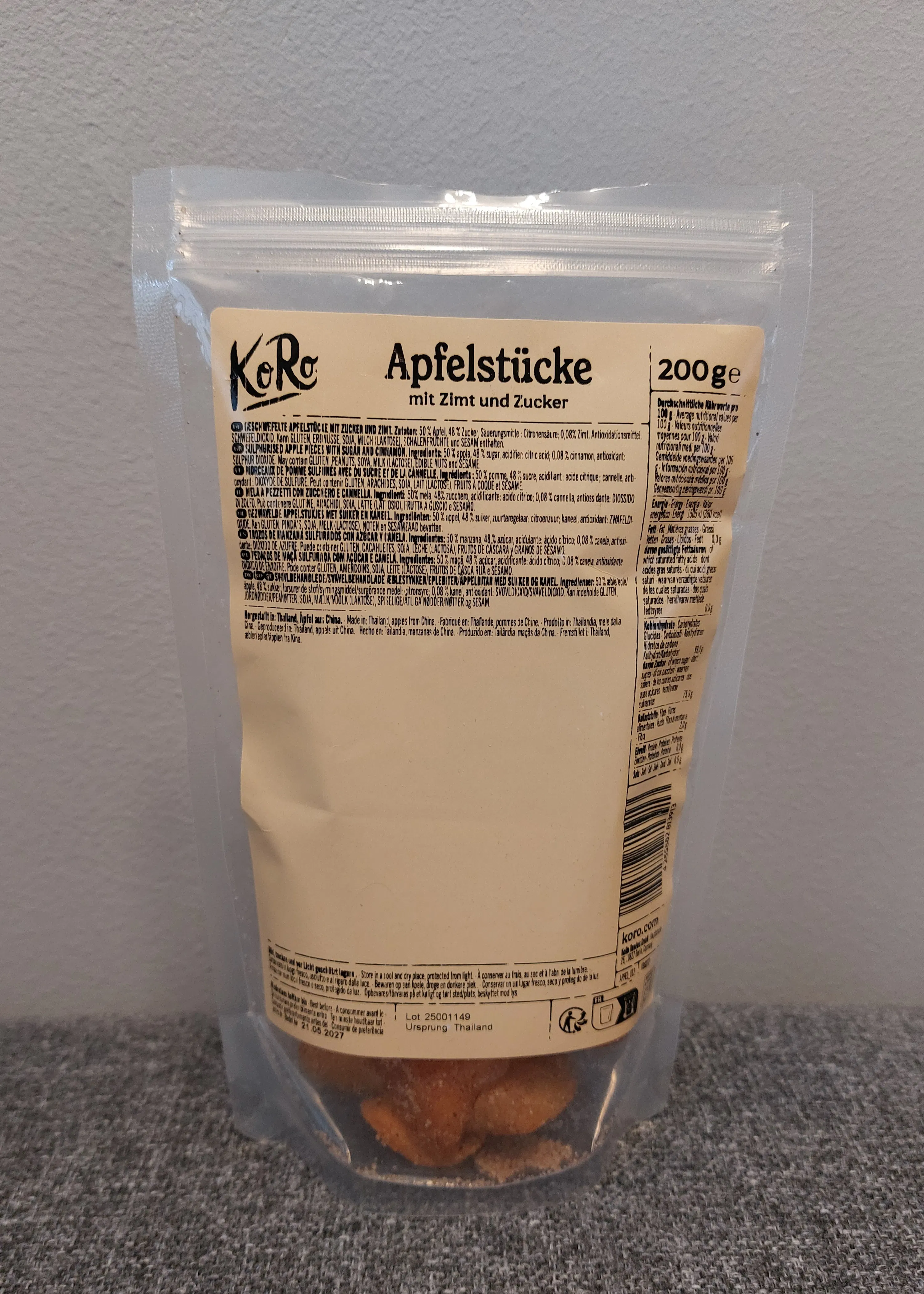 a clear plastic pouch of koro brand dried apple pieces with cinnamon and sugar.