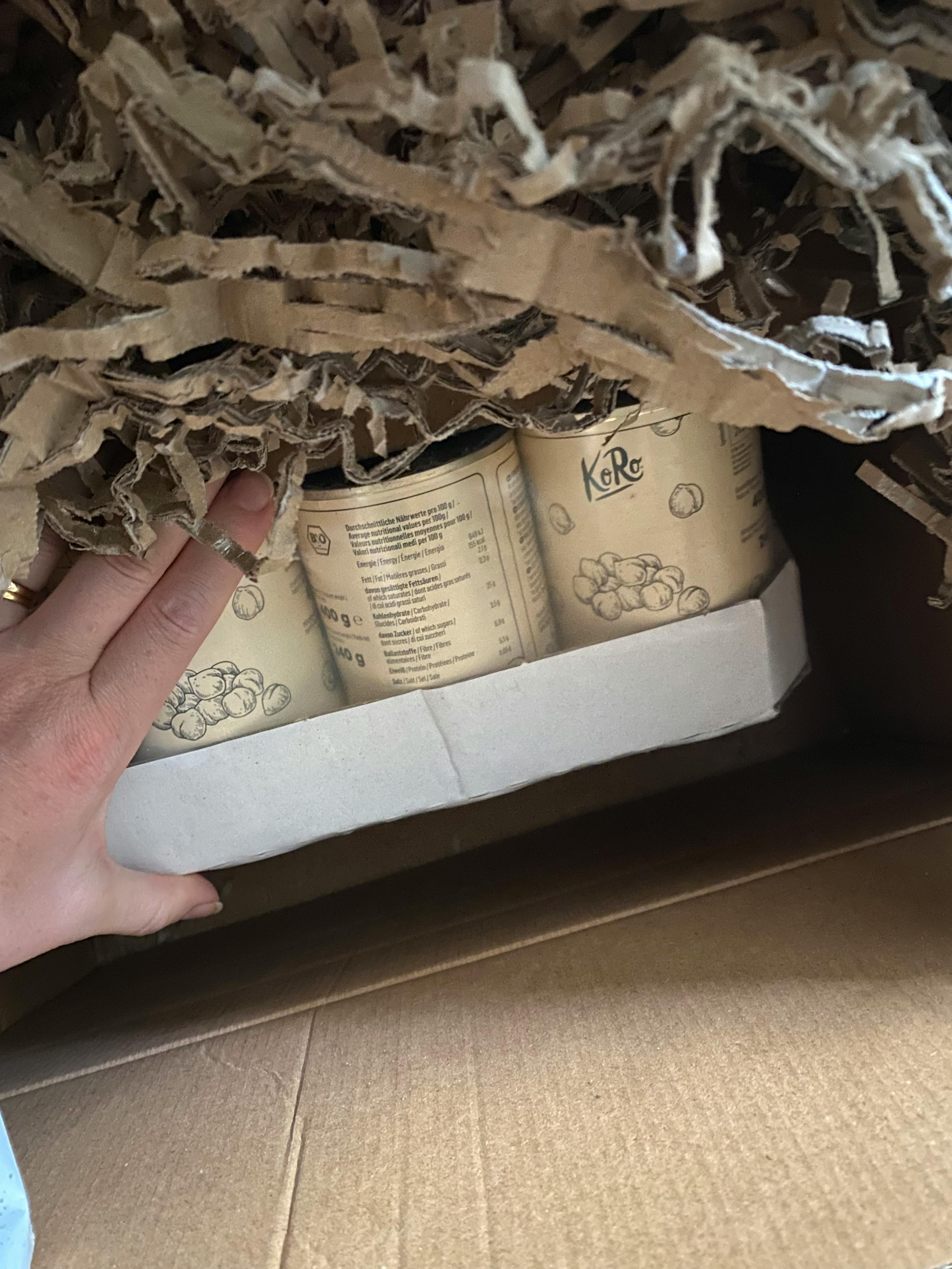 a cardboard box filled with shredded paper and a label that says kabo