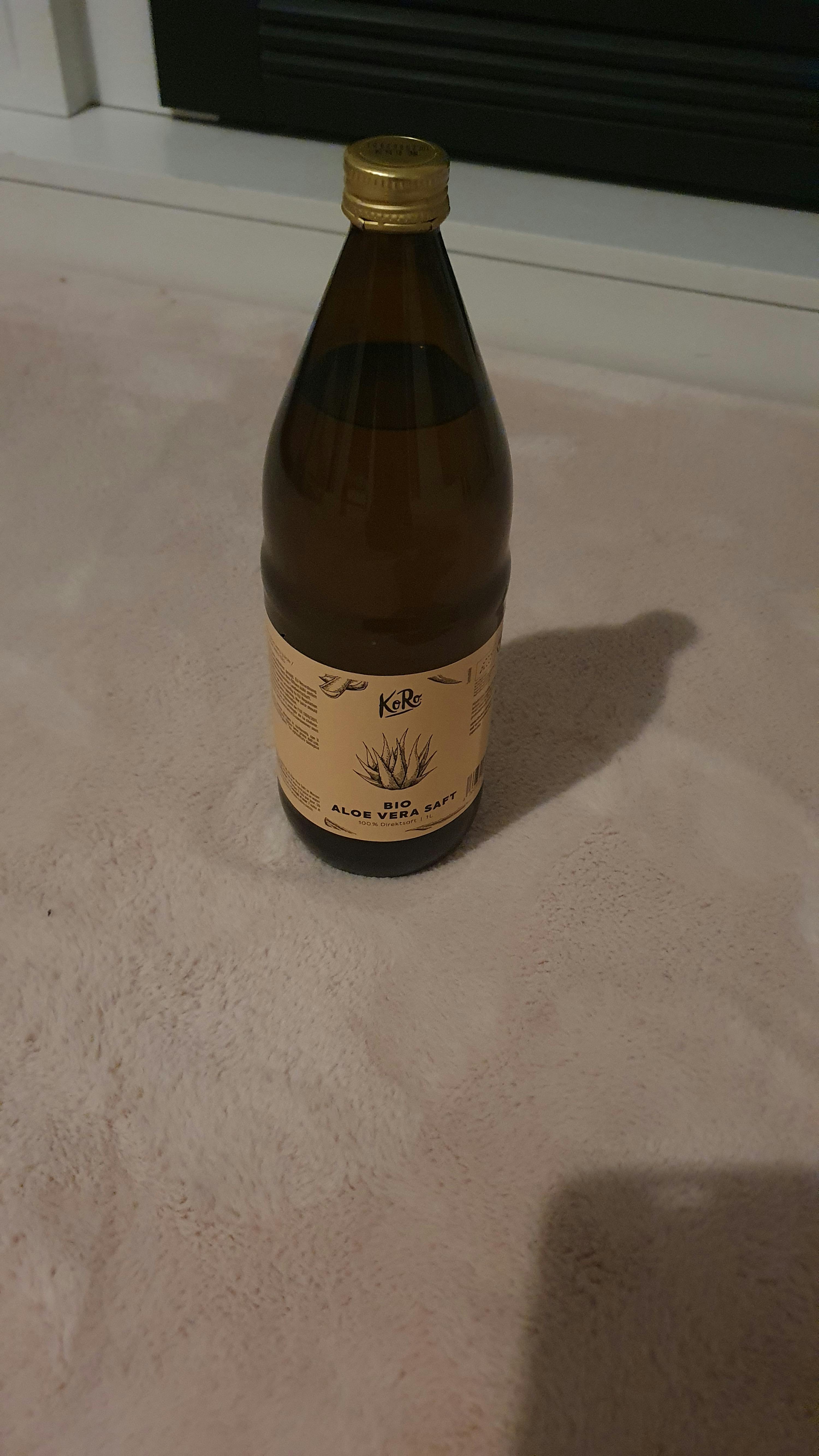 a bottle of aloe vera juice sits on a table