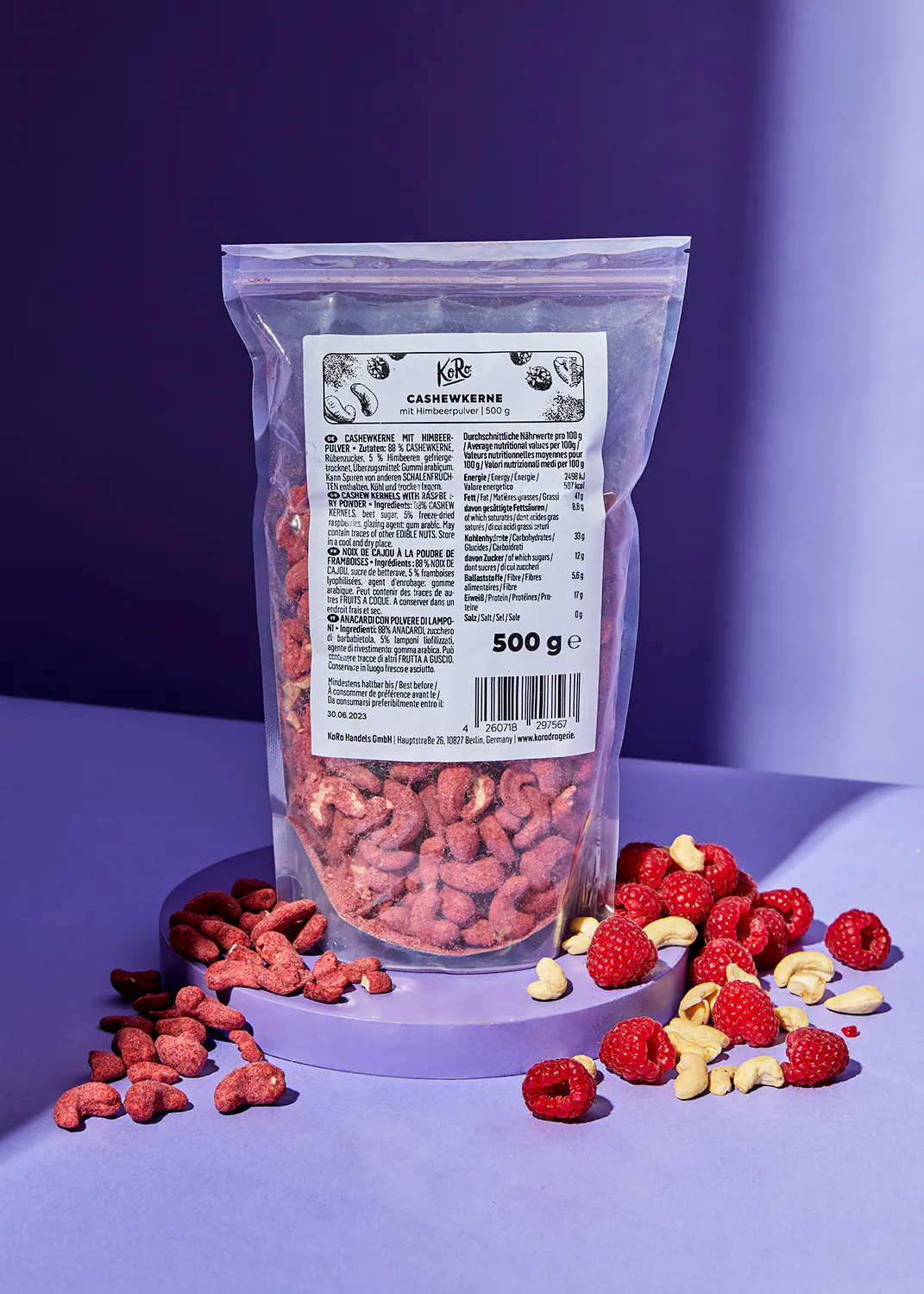 a bag of cashews with raspberries on a table