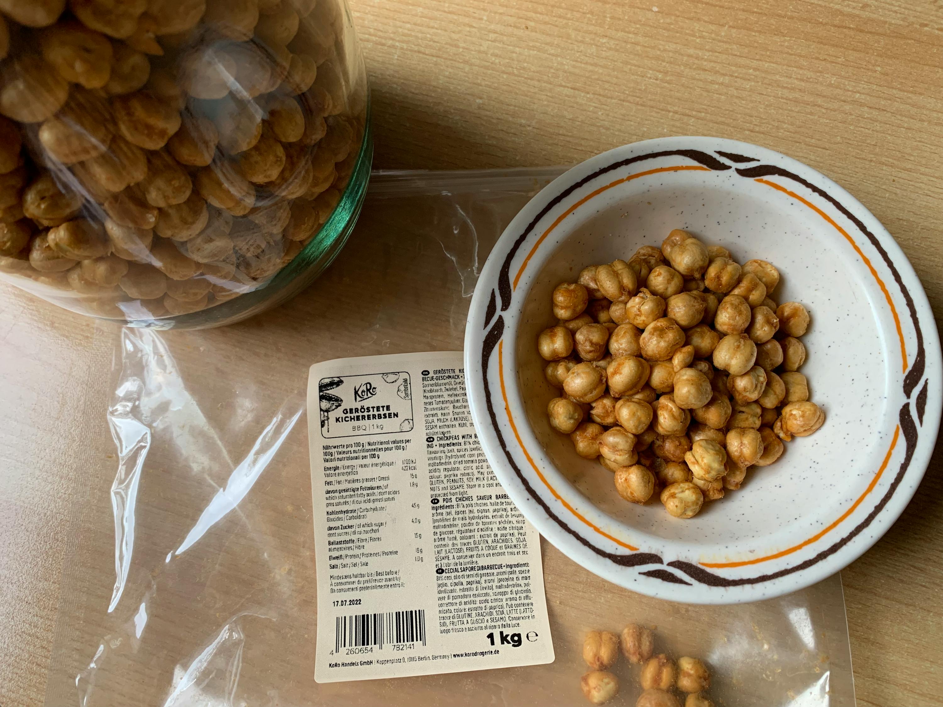 a bowl of chickpeas sits next to a bag of chickpeas
