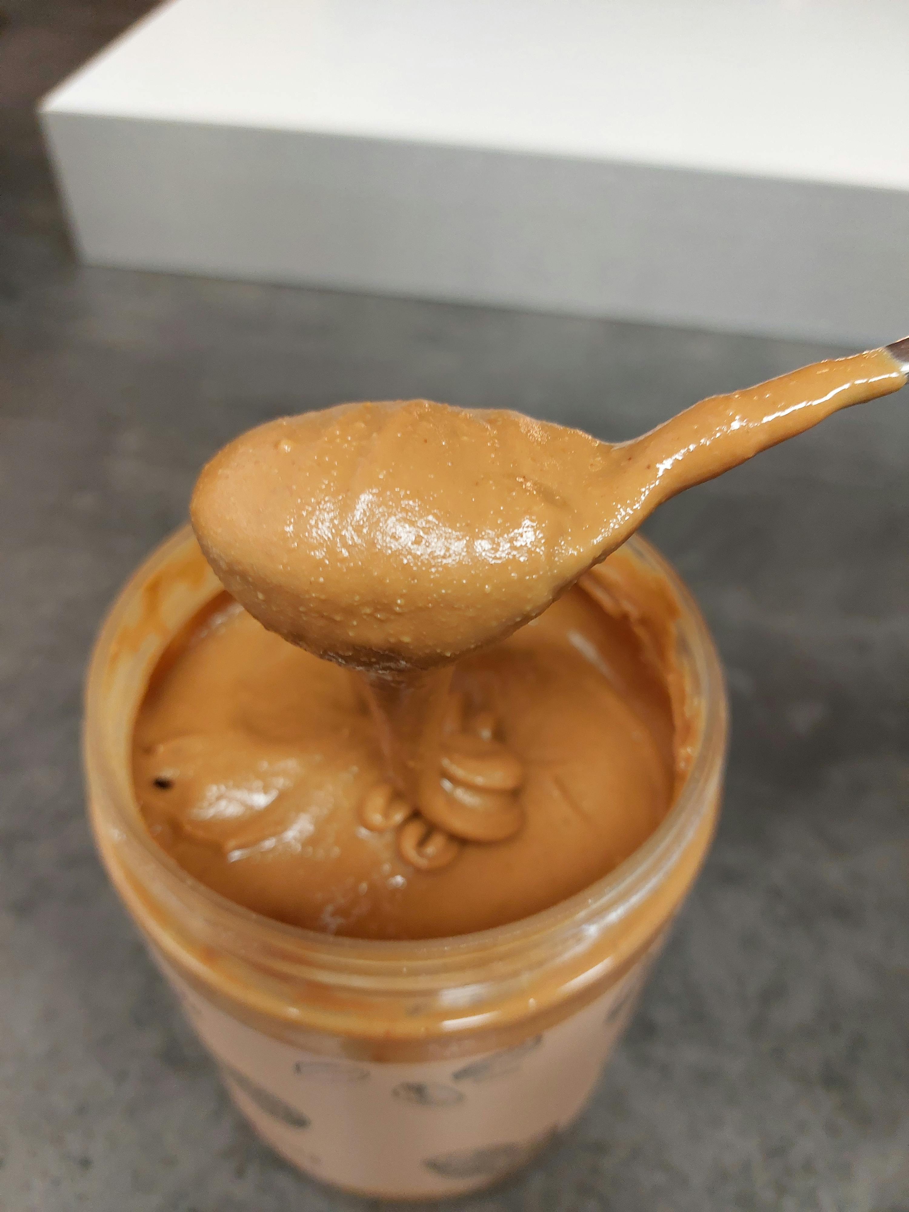 a jar of peanut butter with a spoon in it