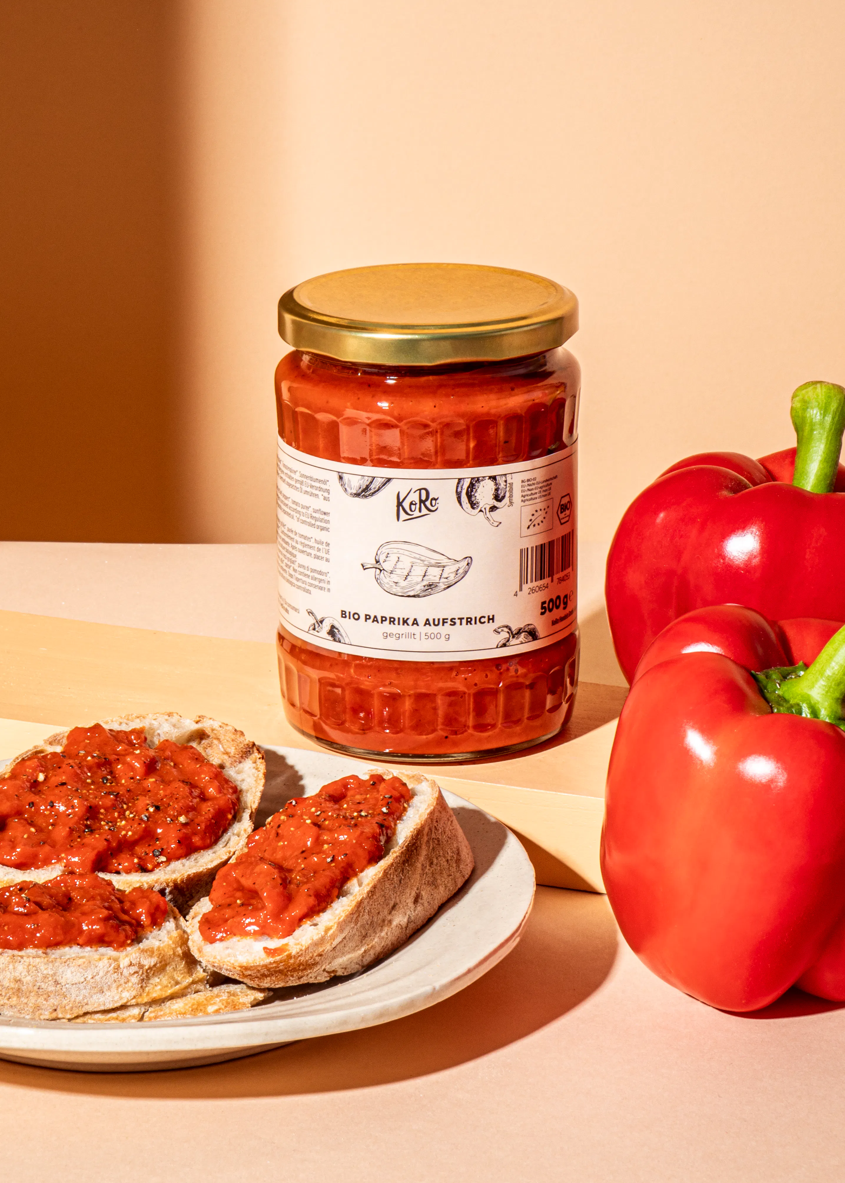 a jar of bio paprika aufstrich next to a plate of food