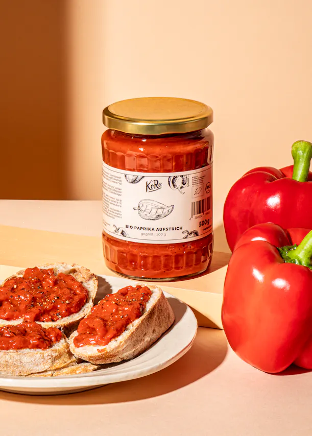 a jar of bio paprika aufstrich next to a plate of food
