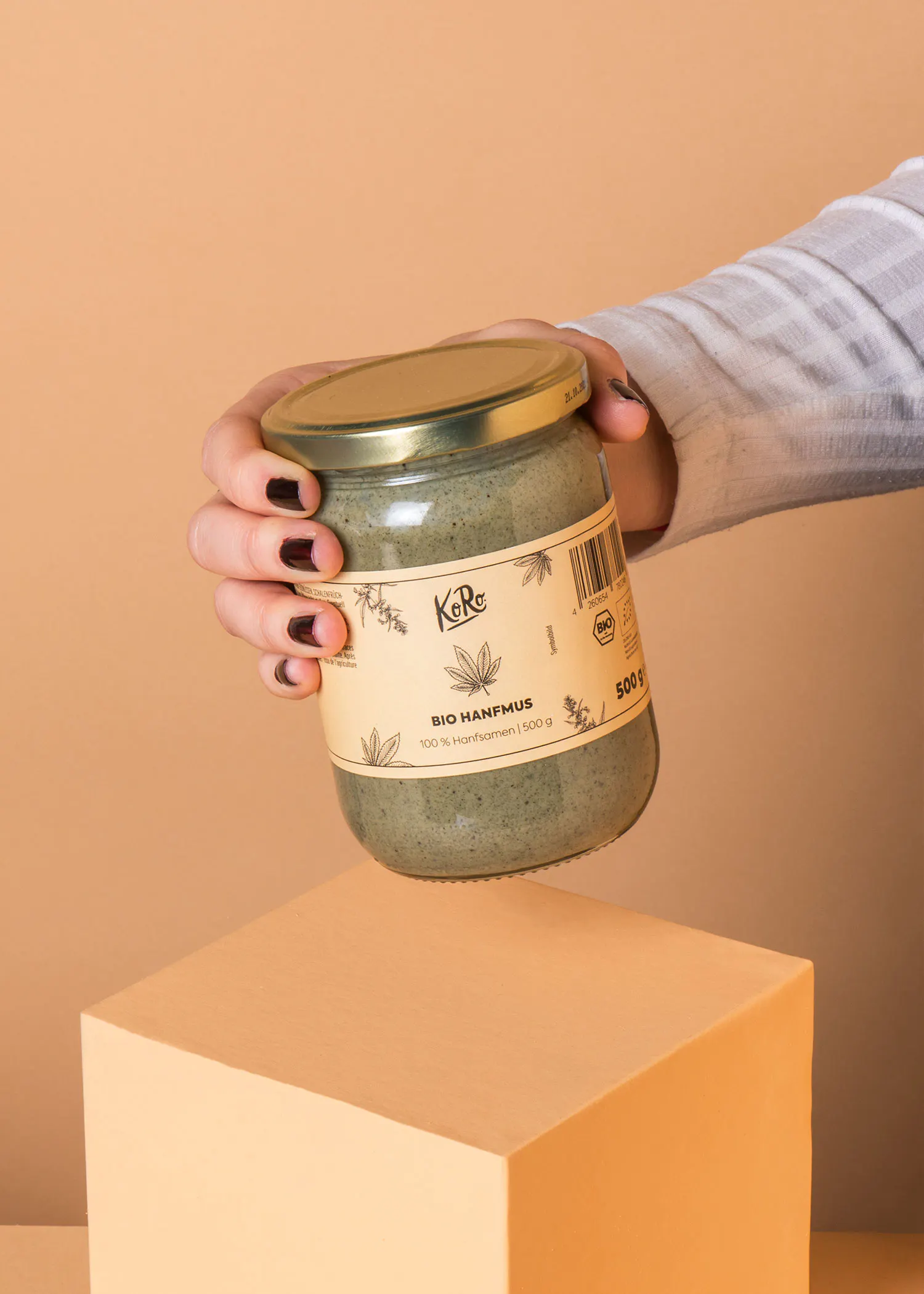 a person holding a jar of bio hanfmus