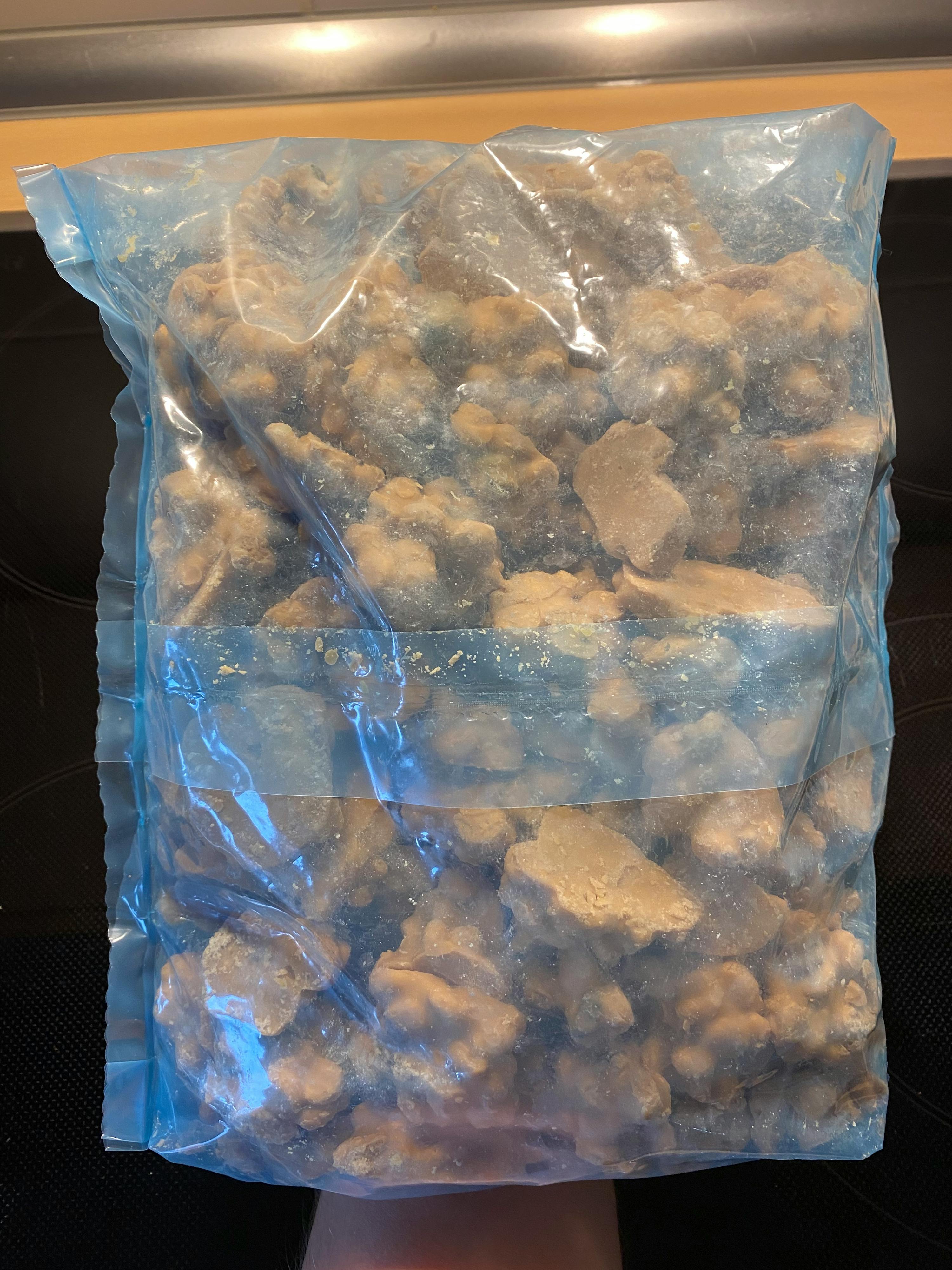 a bag of chicken nuggets is sitting on a stove top