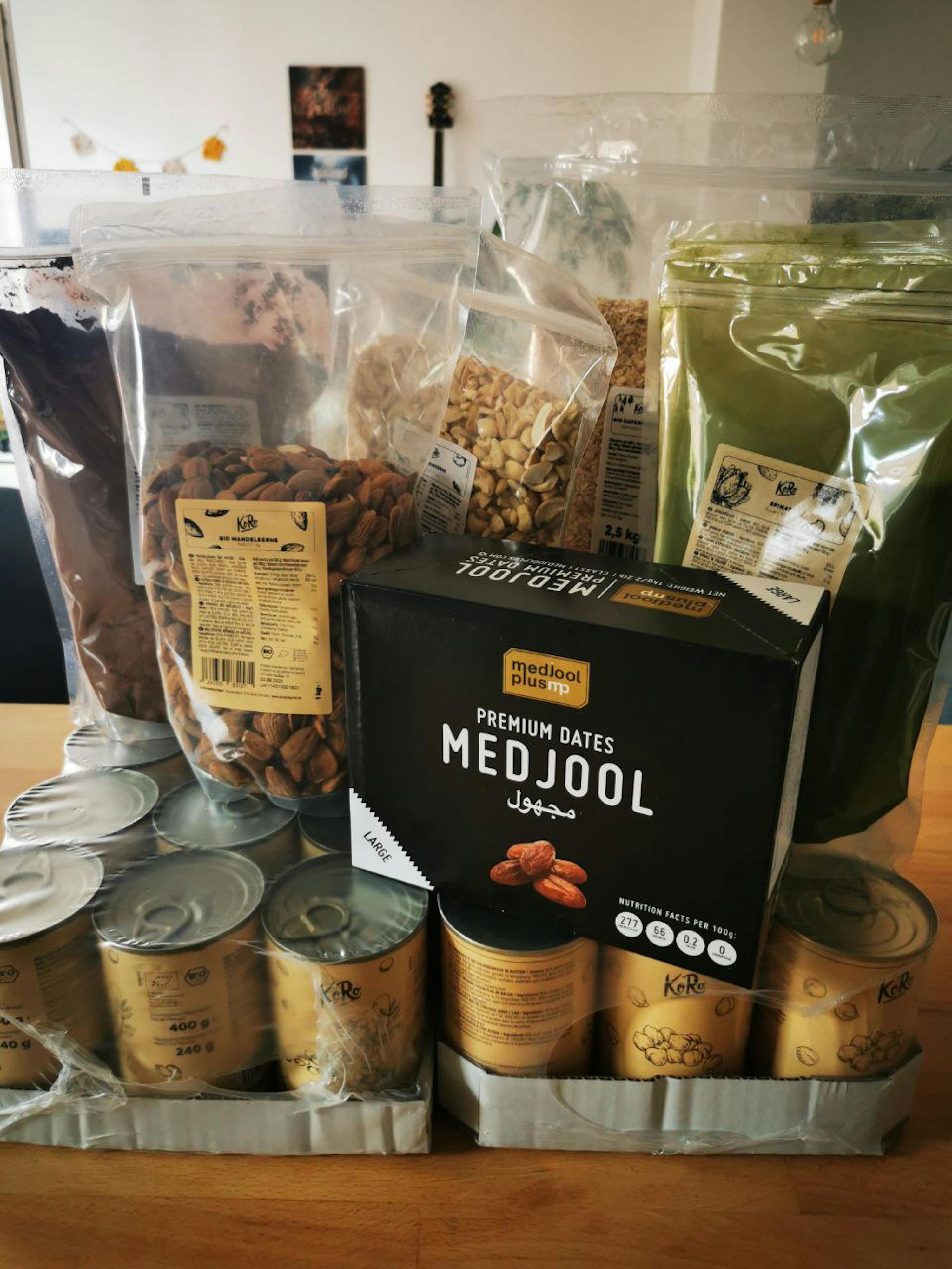 a box of medjool premium dates sits on a wooden table