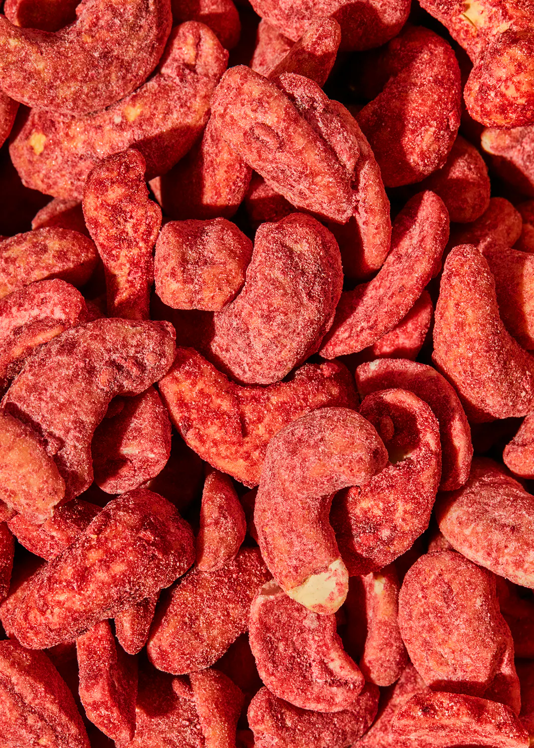a close up of a pile of red nuts