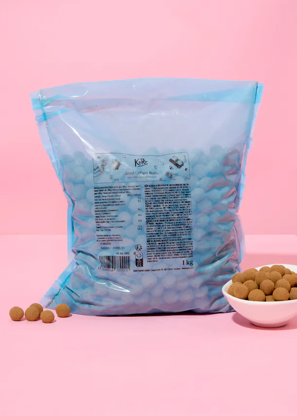 a bag of kabe crispy balls sits on a pink surface
