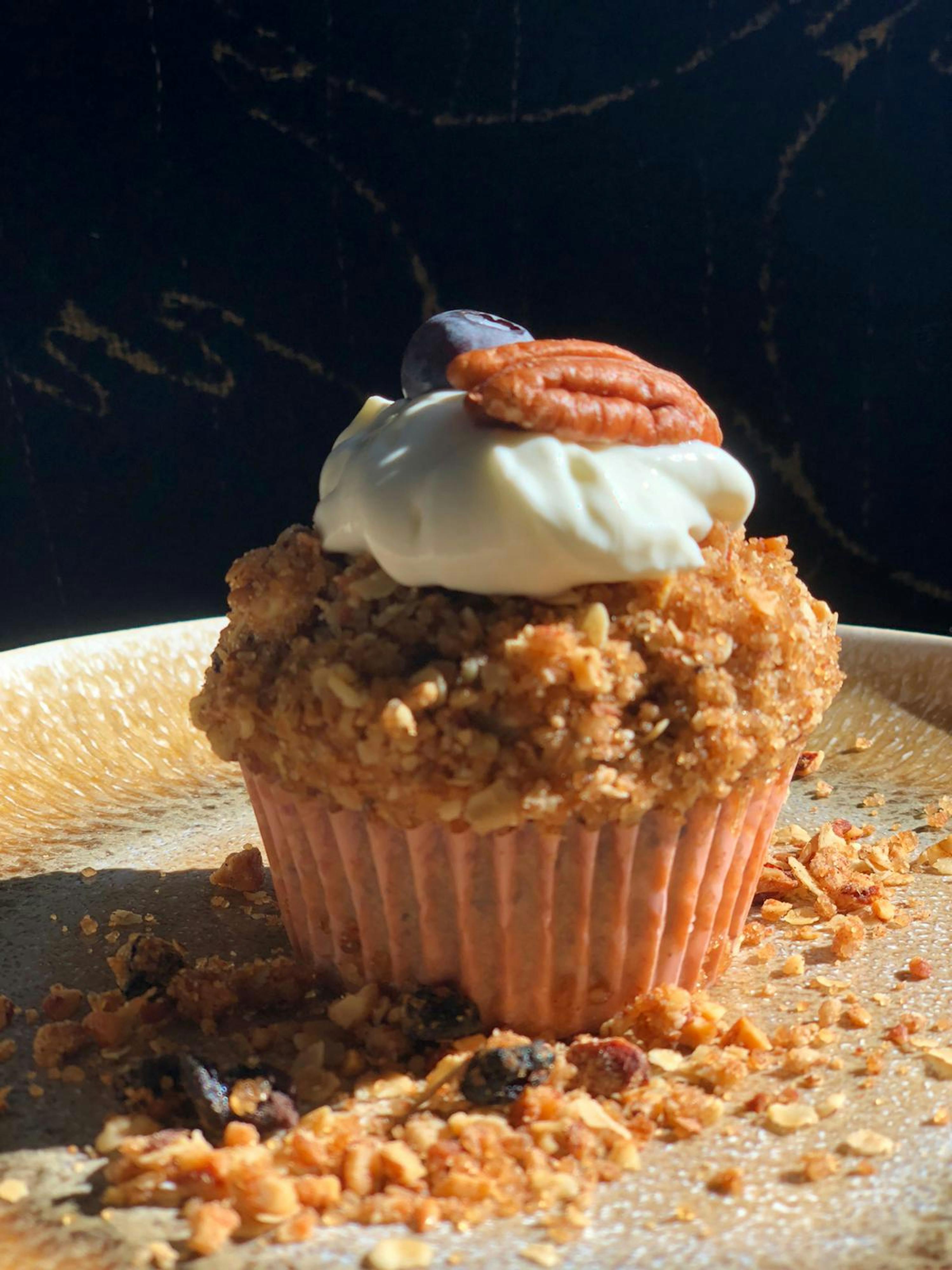 a cupcake with a pecan on top of it