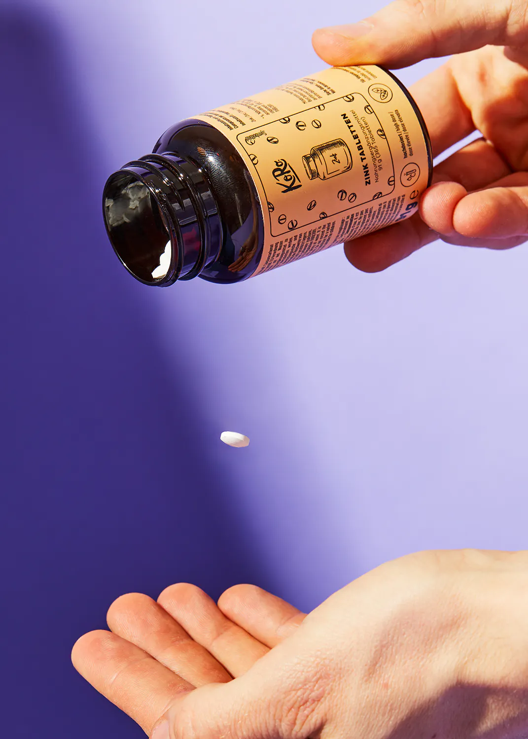 a person is pouring a pill into their hand from a bottle that says ginger ale