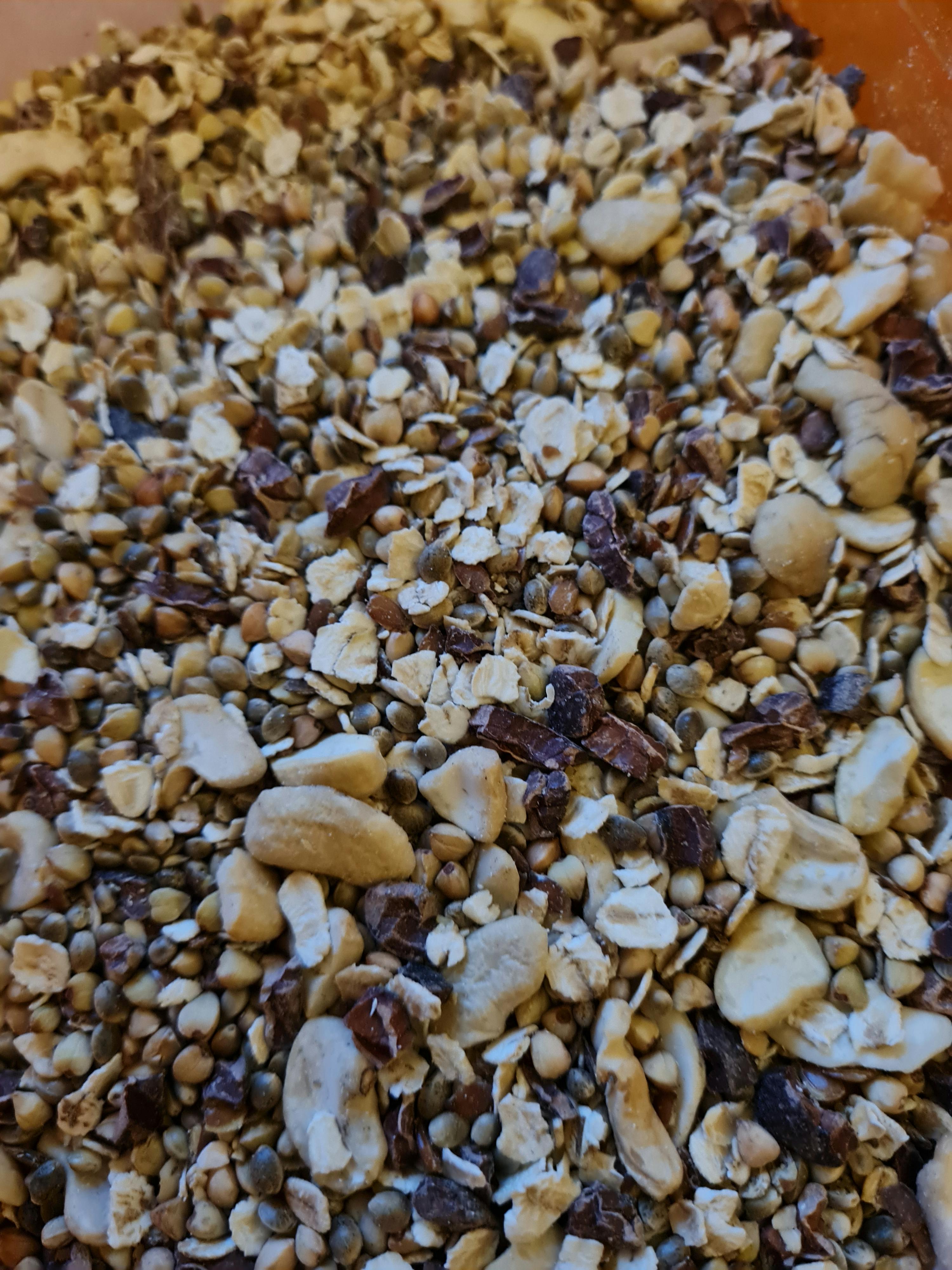a close up of a pile of nuts and grains