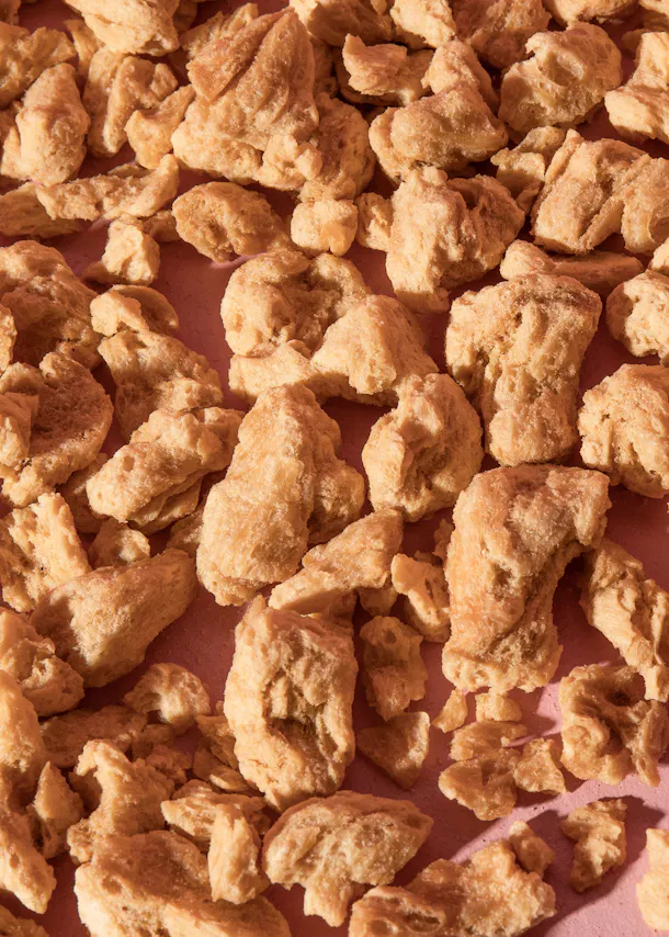 un tas de morceaux de soja sur une surface rose