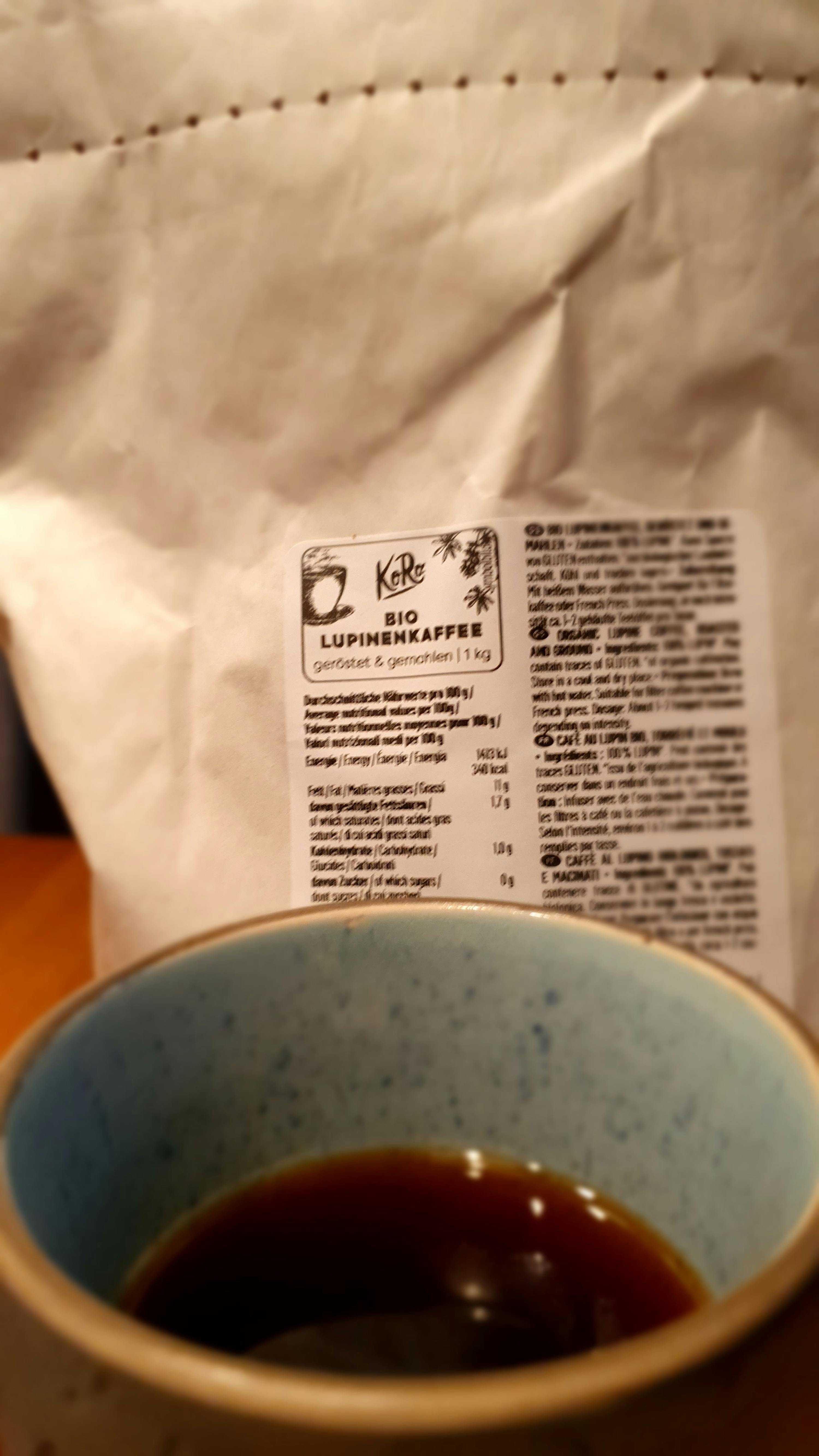a bag of bio coffee is next to a cup of coffee