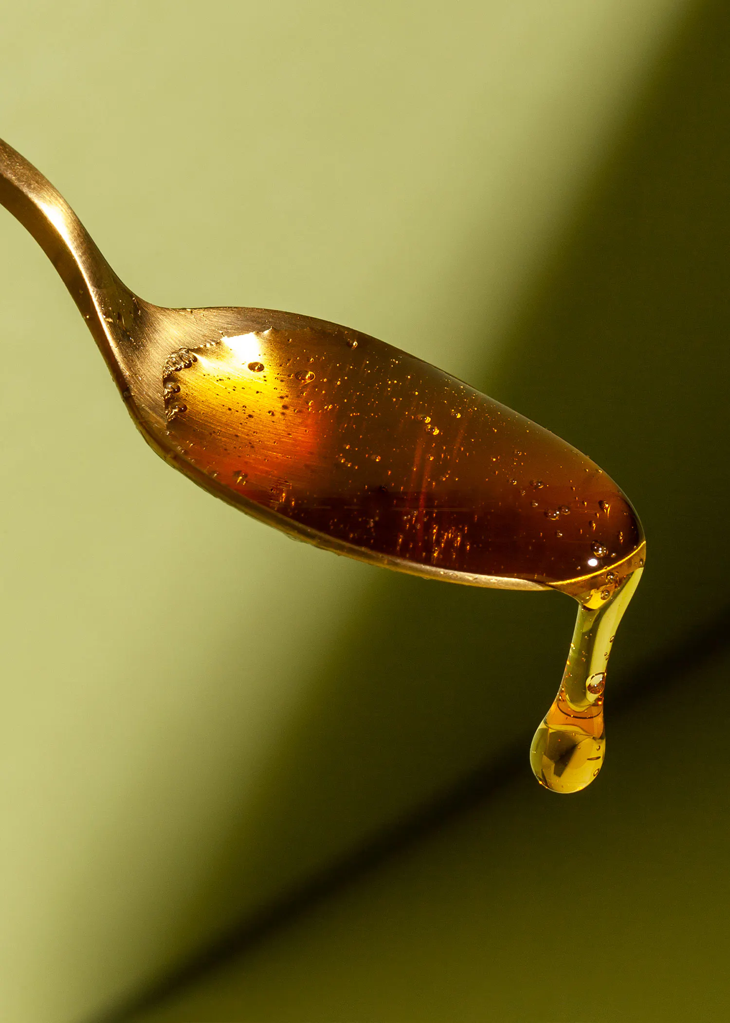 a spoon with a drop of liquid on it