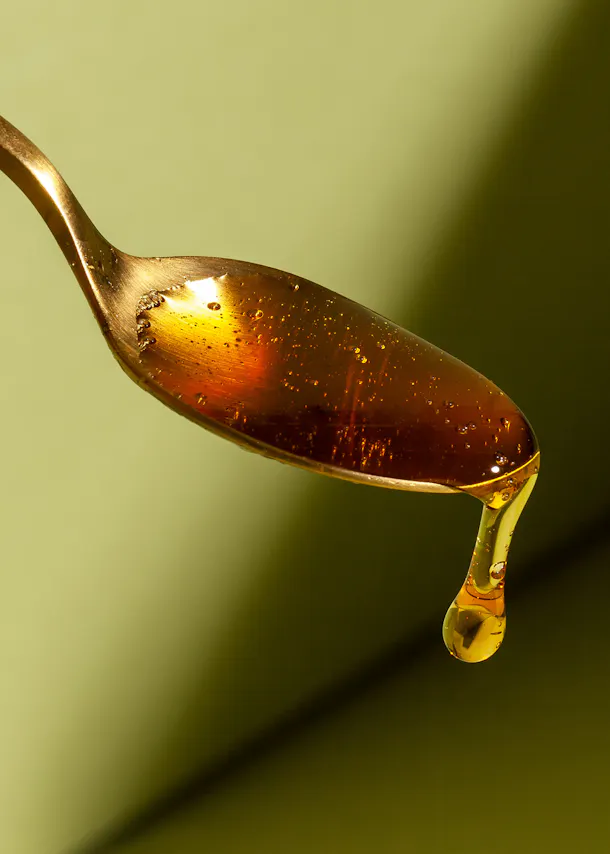 a spoon with a drop of liquid on it