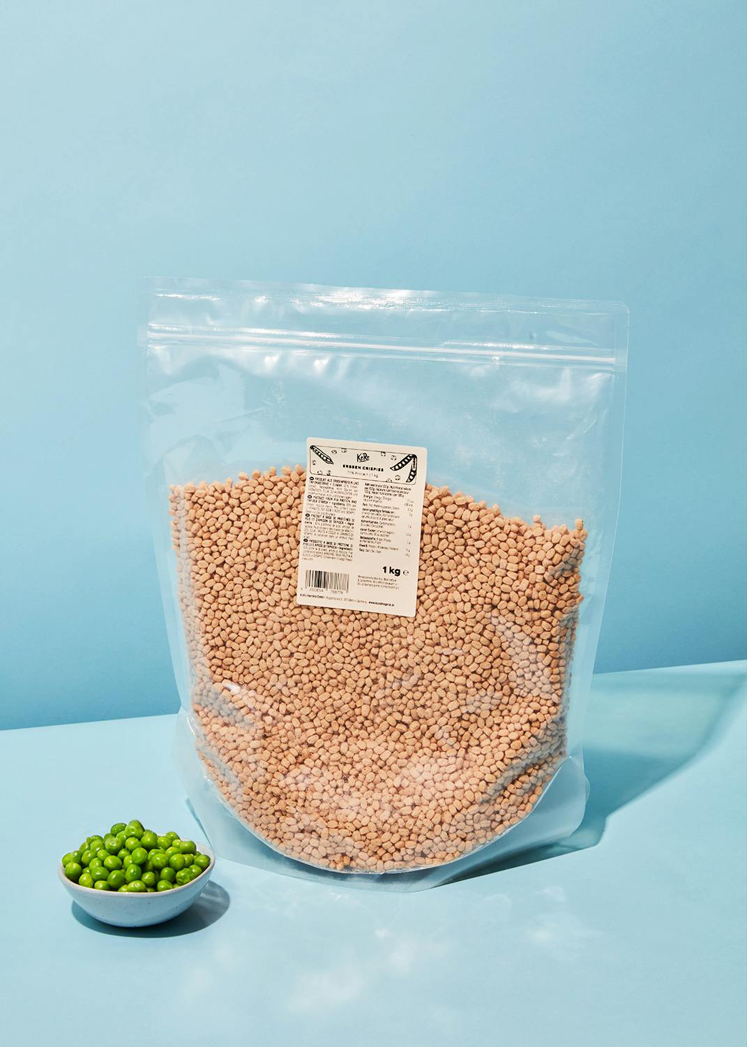 Pea 71% protein crispies 1kg a bag of lentils sits next to a bowl of peas