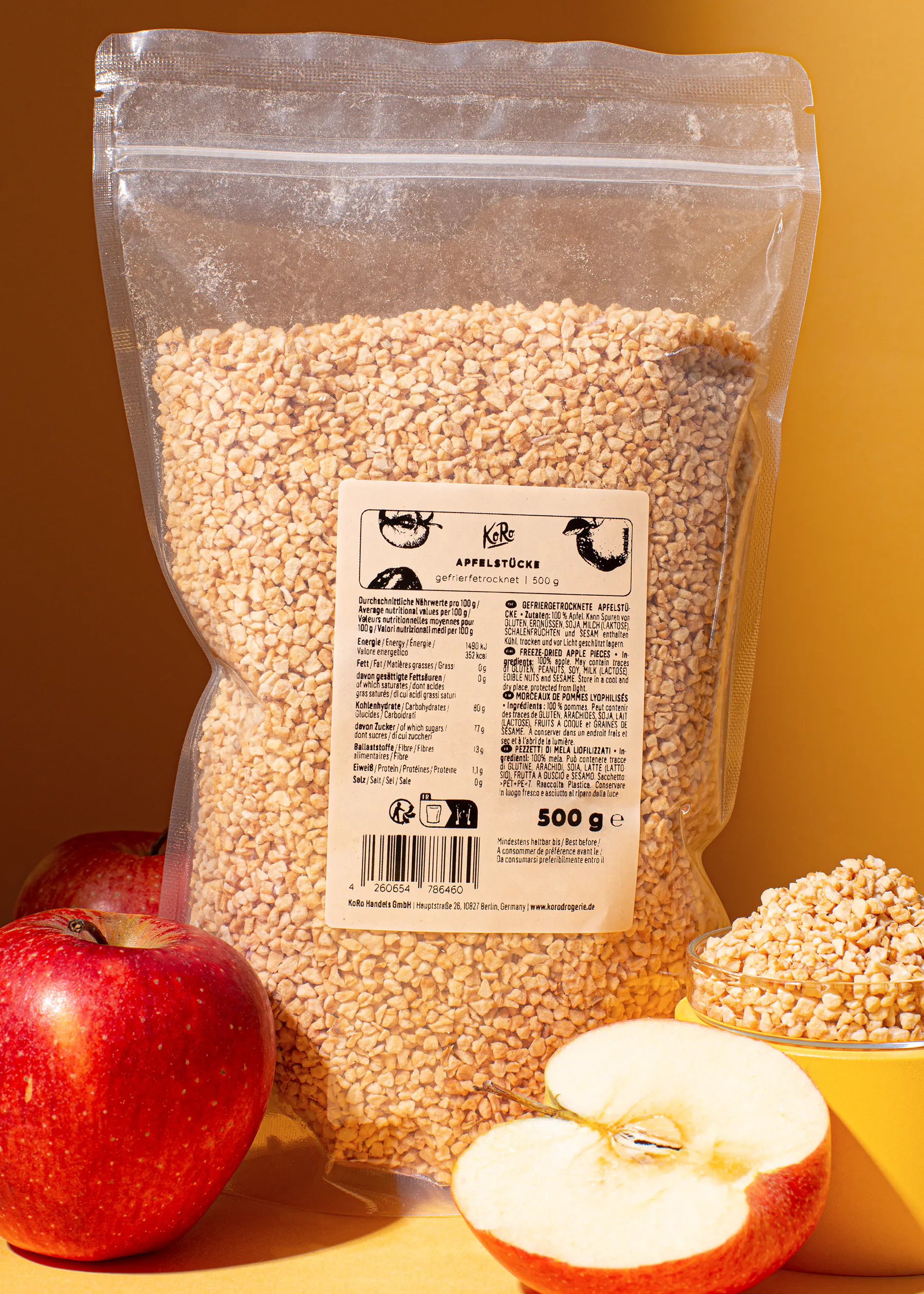 a bag of apple sticks sits on a table next to apples