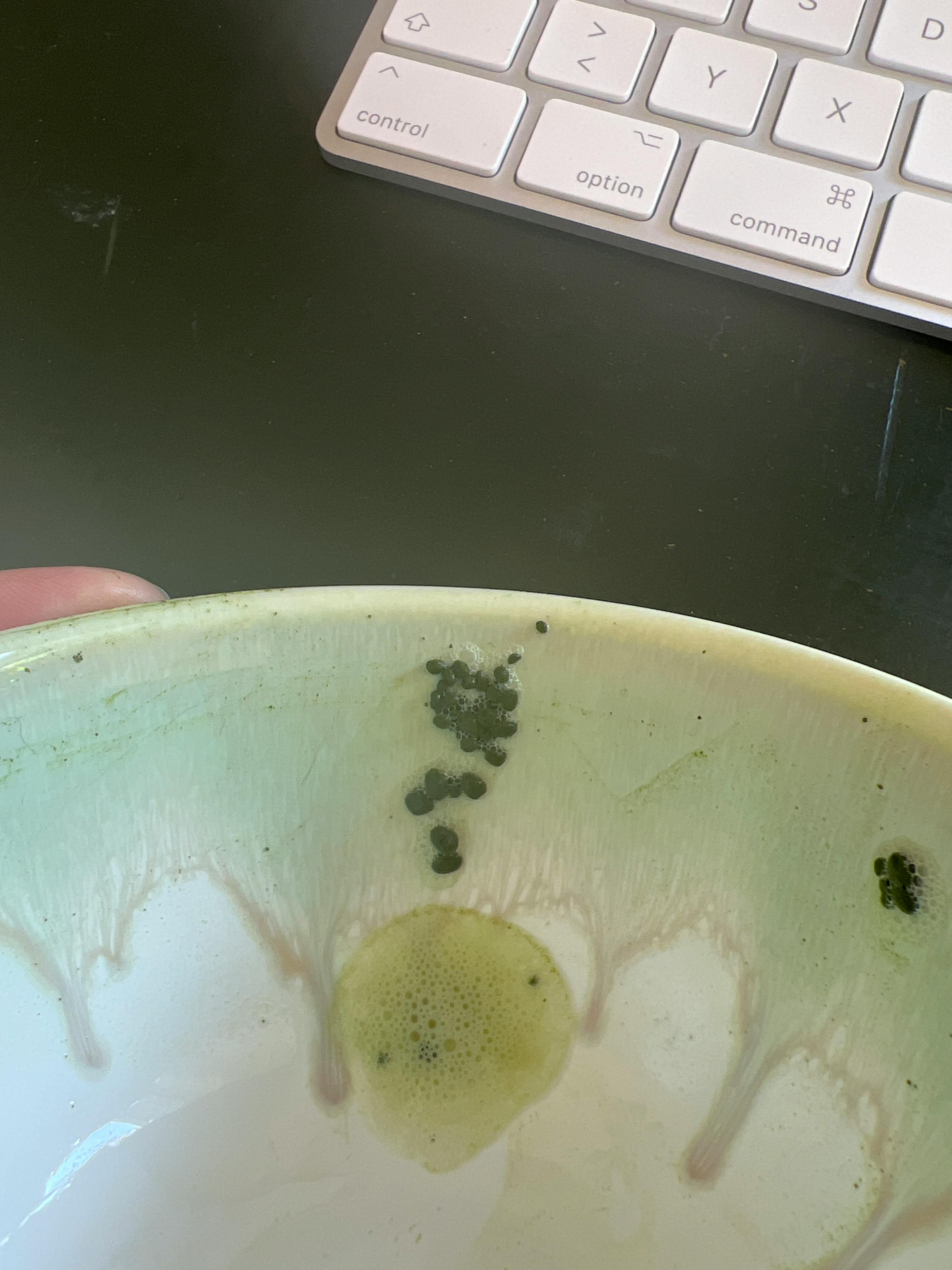 a person is holding a bowl next to a keyboard that says command