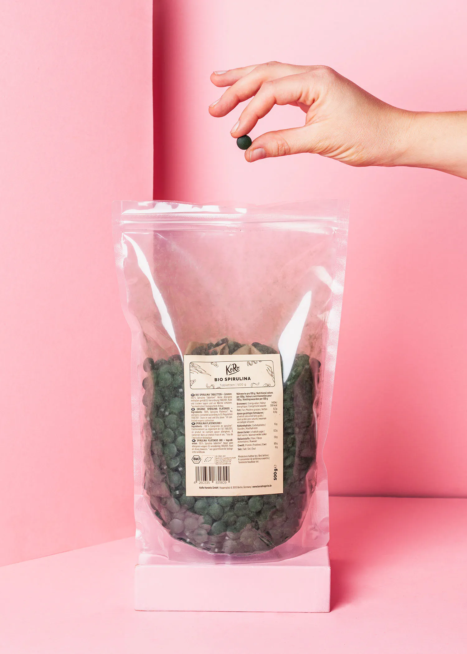 a bag of bio spirulina is being held by a hand