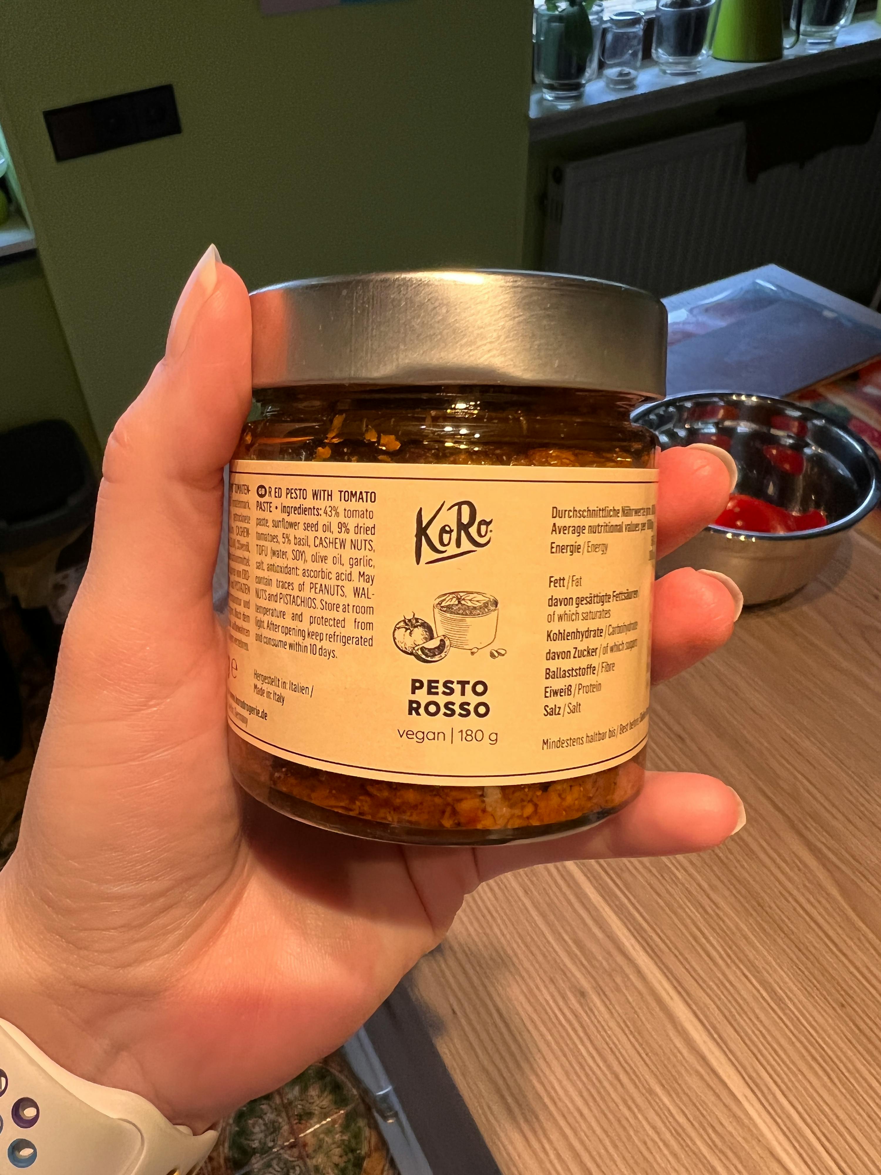 persona che tiene in mano un barattolo di pesto rosso