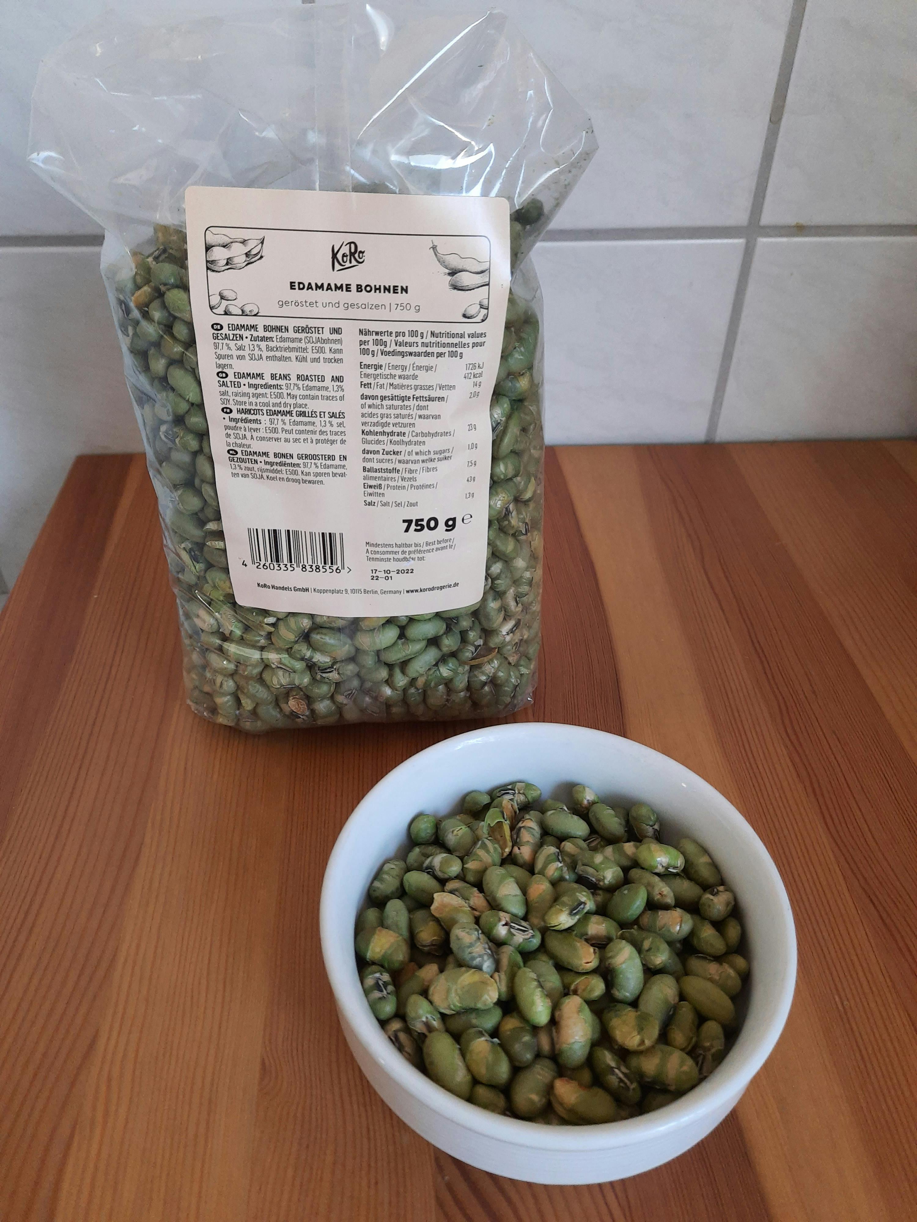 a bag of green beans sits next to a bowl of green beans