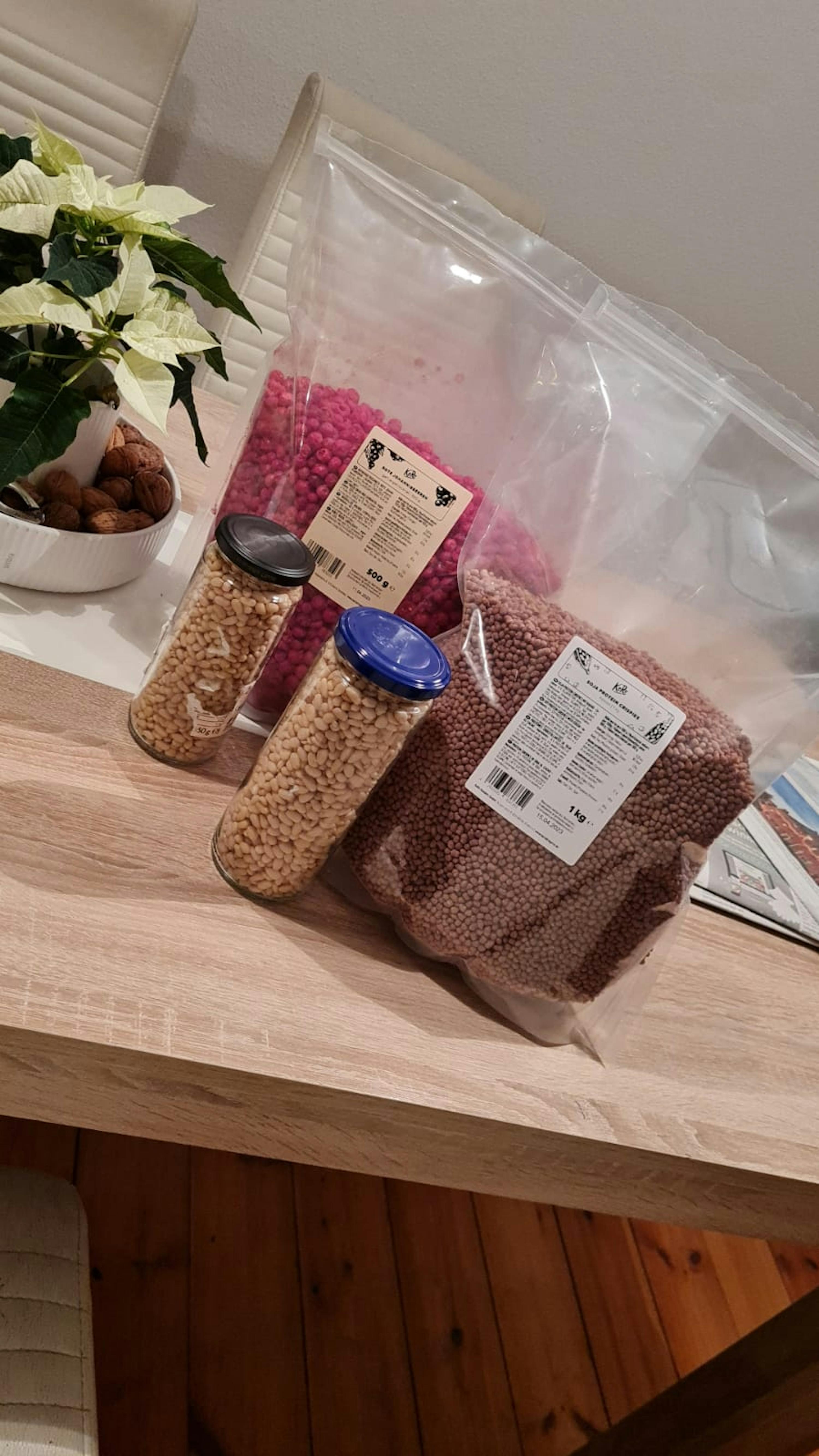 two jars of beans and a bag of red beans are on a table