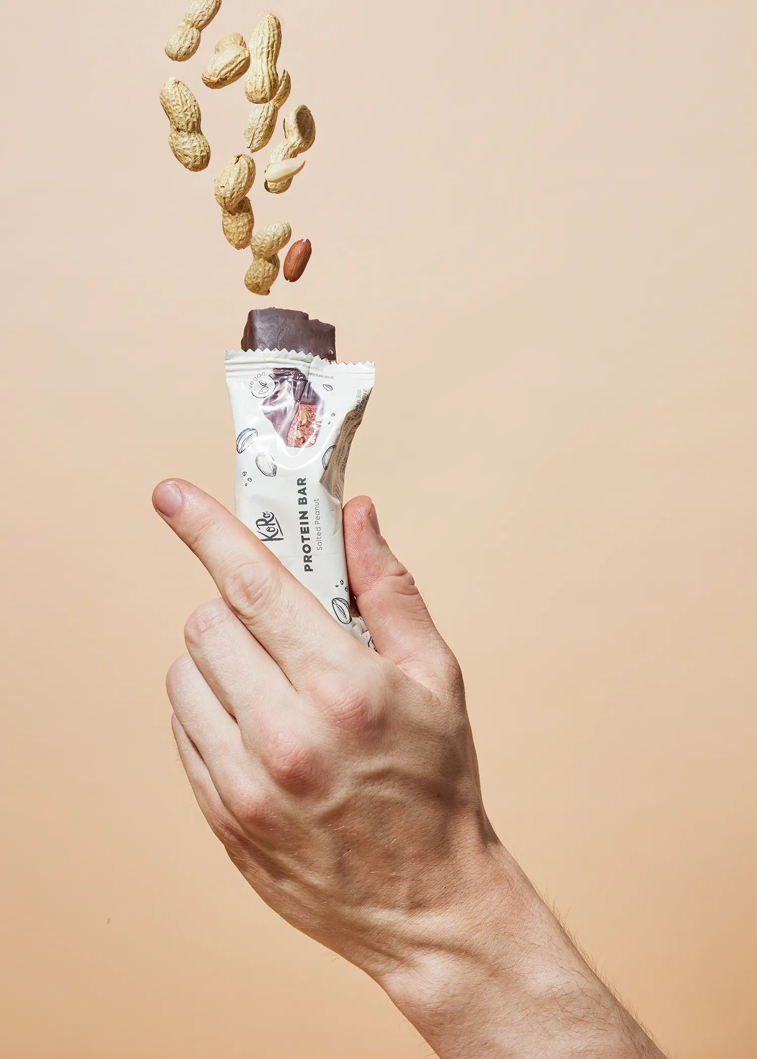 a person is holding a protein bar in their hand
