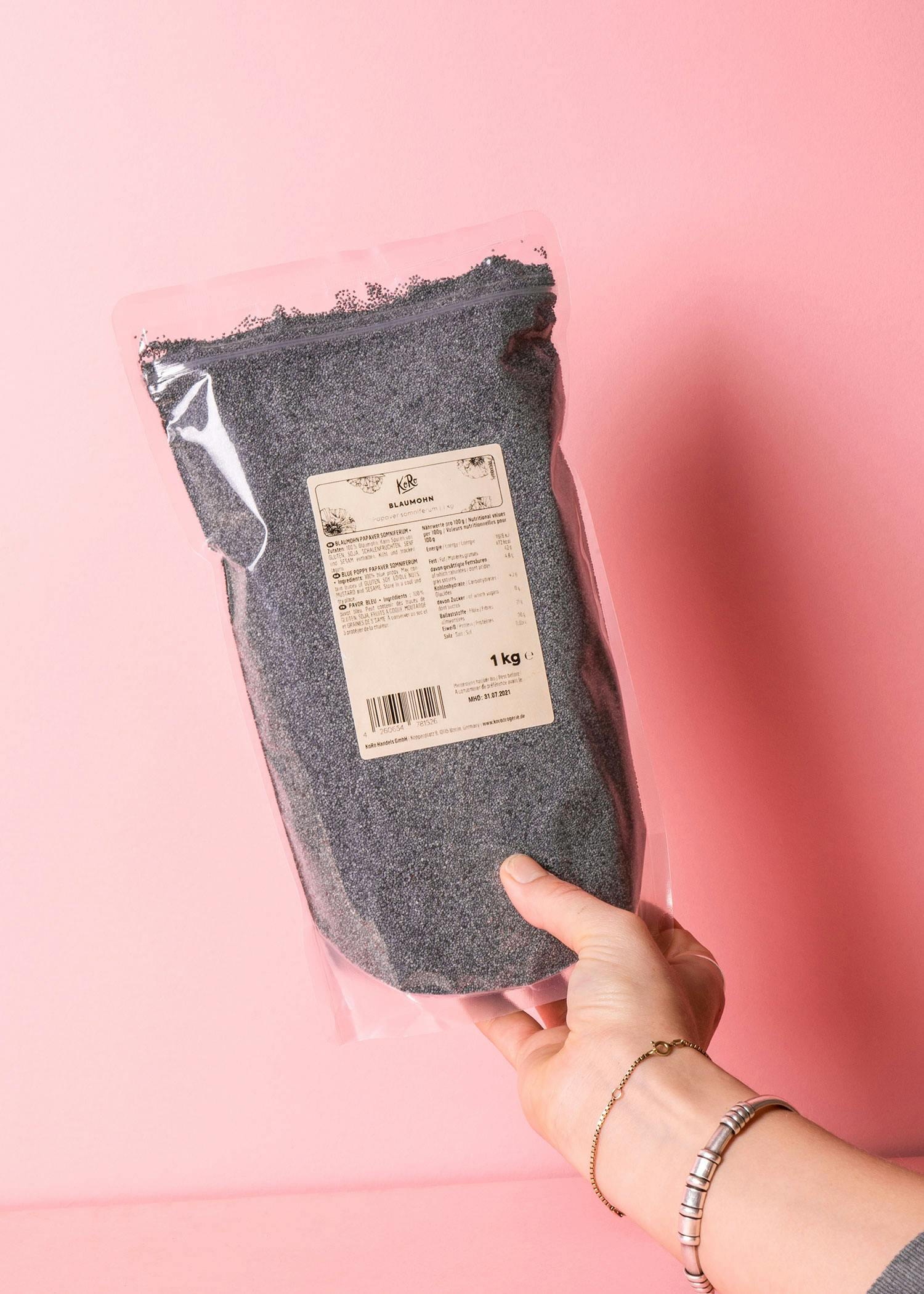 a person is holding a bag of poppy seeds