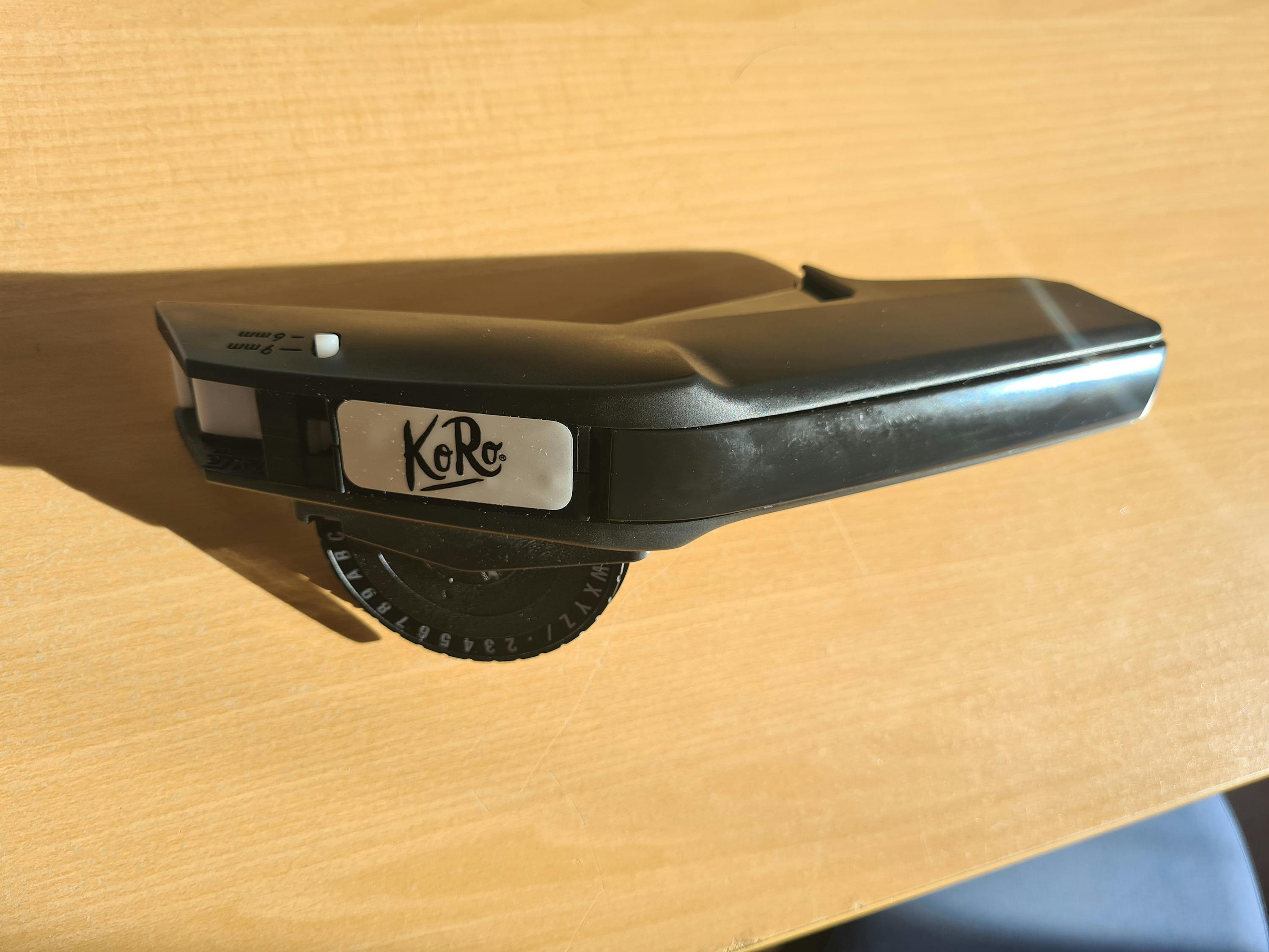 a black item with a white label that says ' kore ' on it
