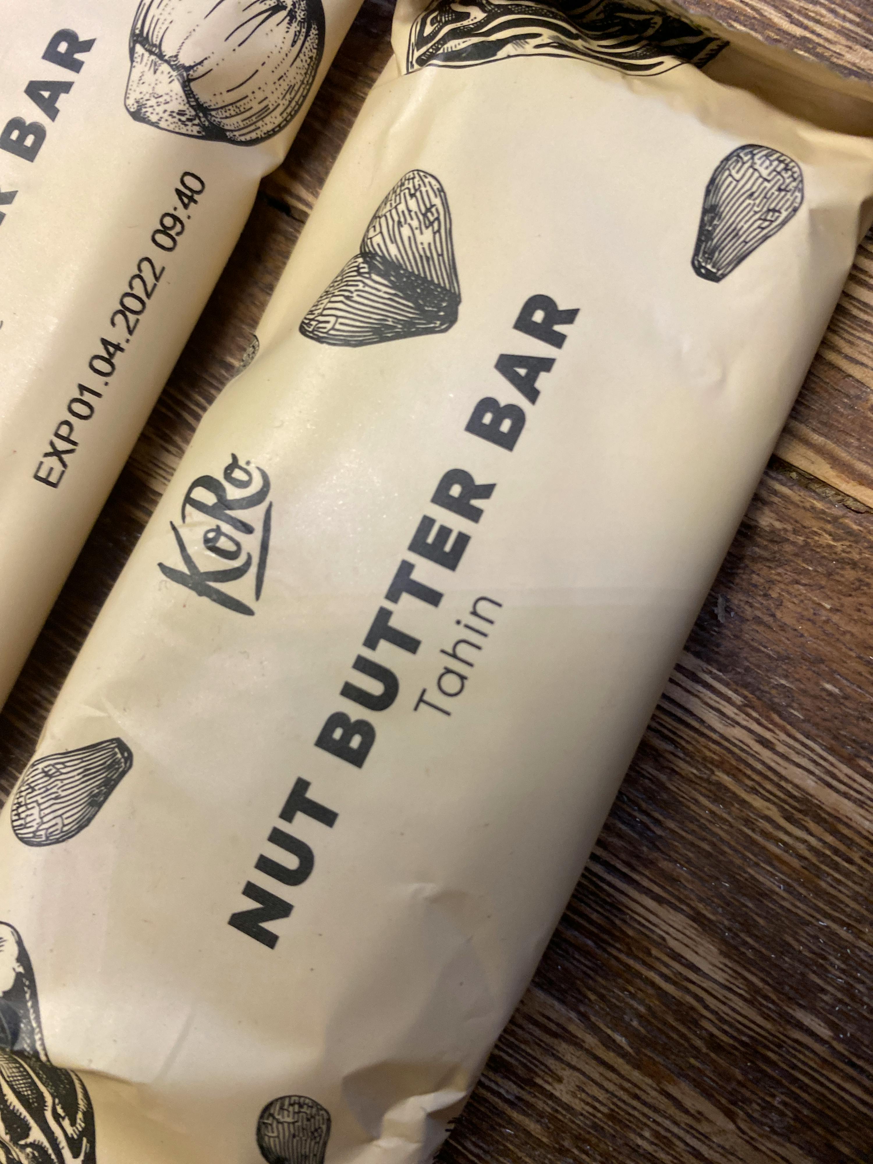 a close up of a nut butter bar on a wooden surface