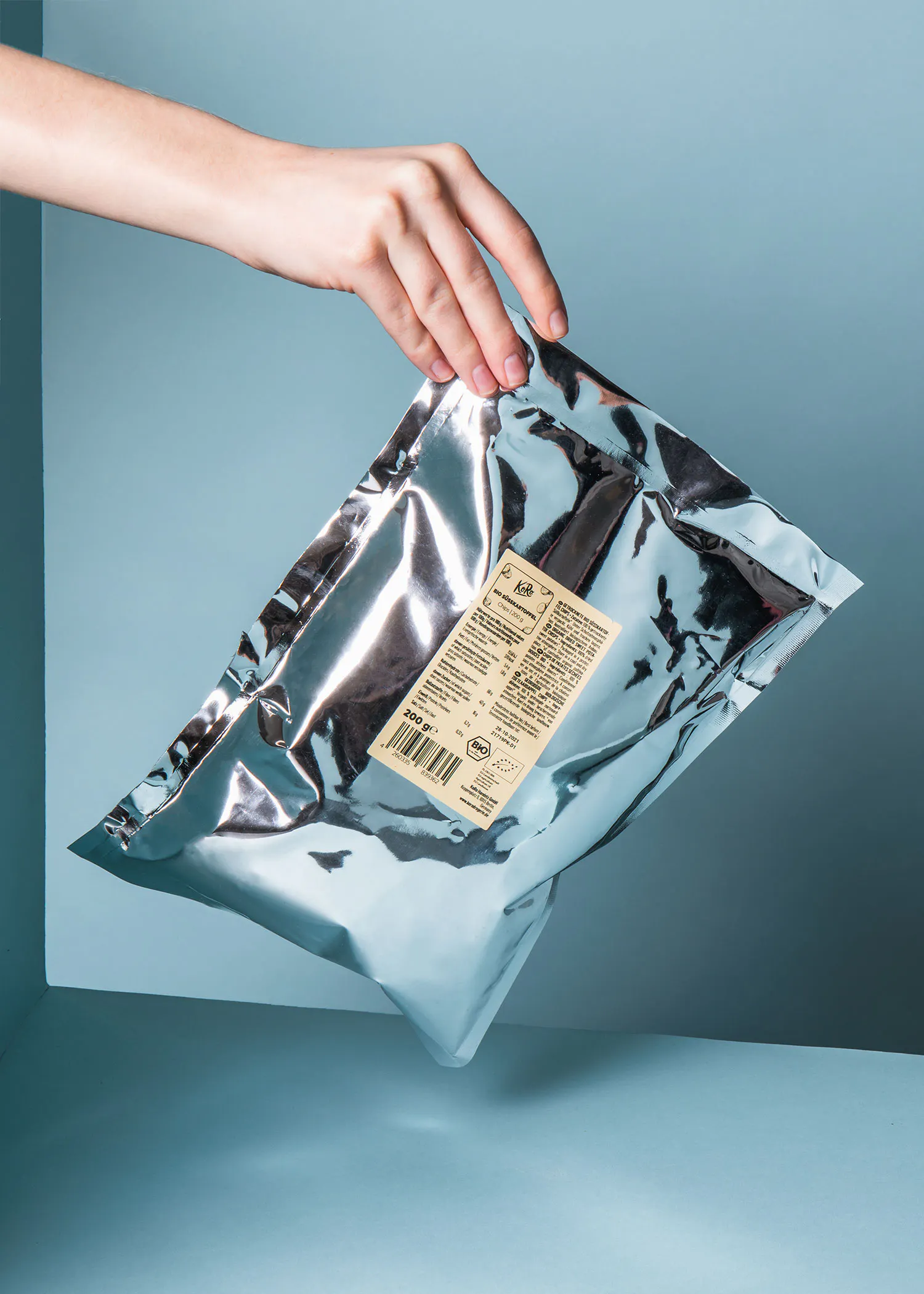 a person is holding a bag of food with a label on it