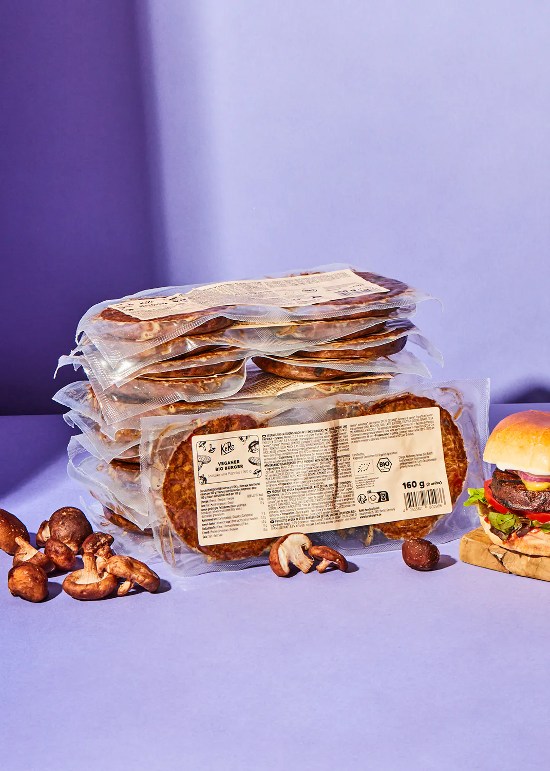 a stack of burger patties sitting next to a hamburger