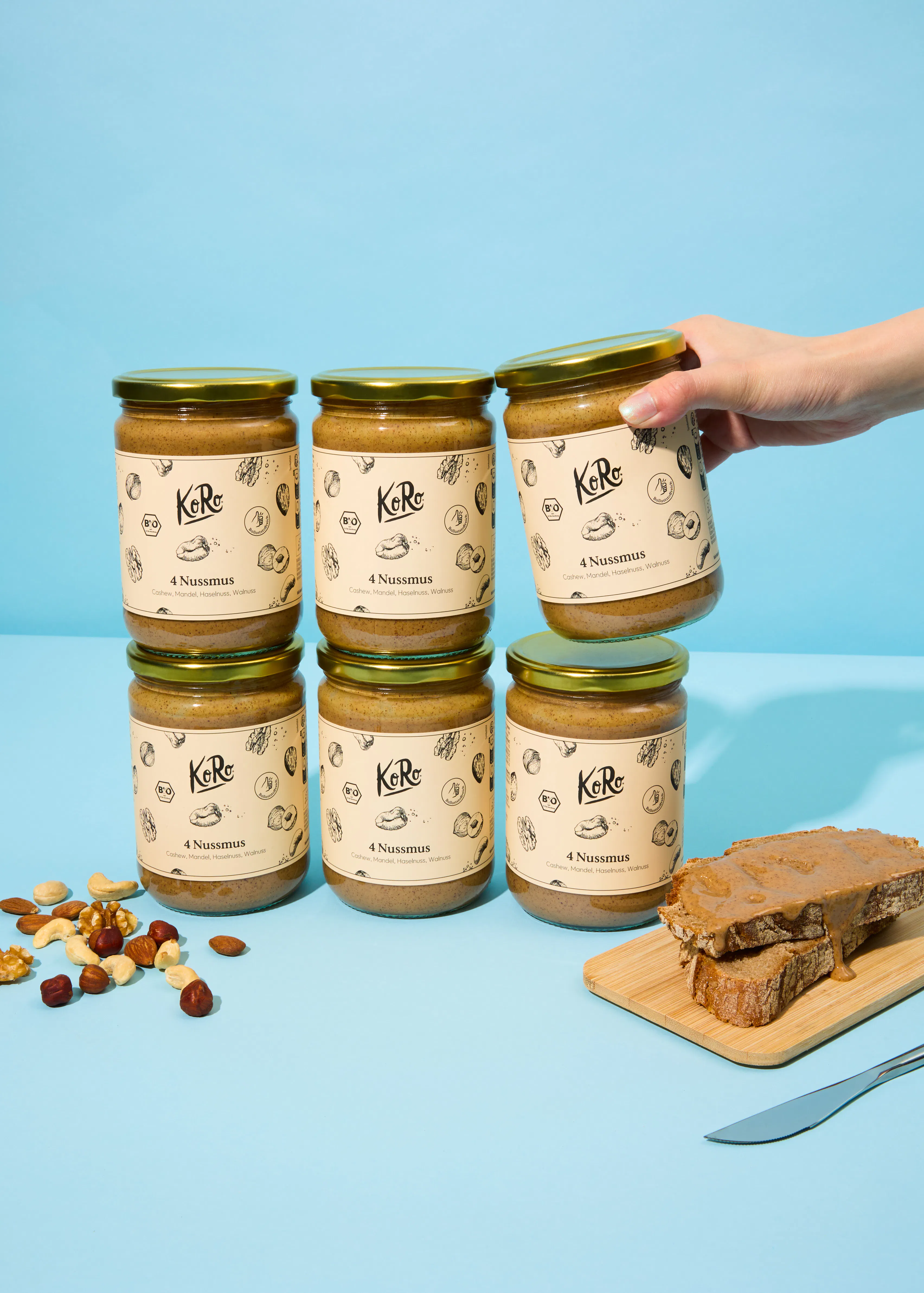 six jars of peanut butter are stacked on top of each other on a table