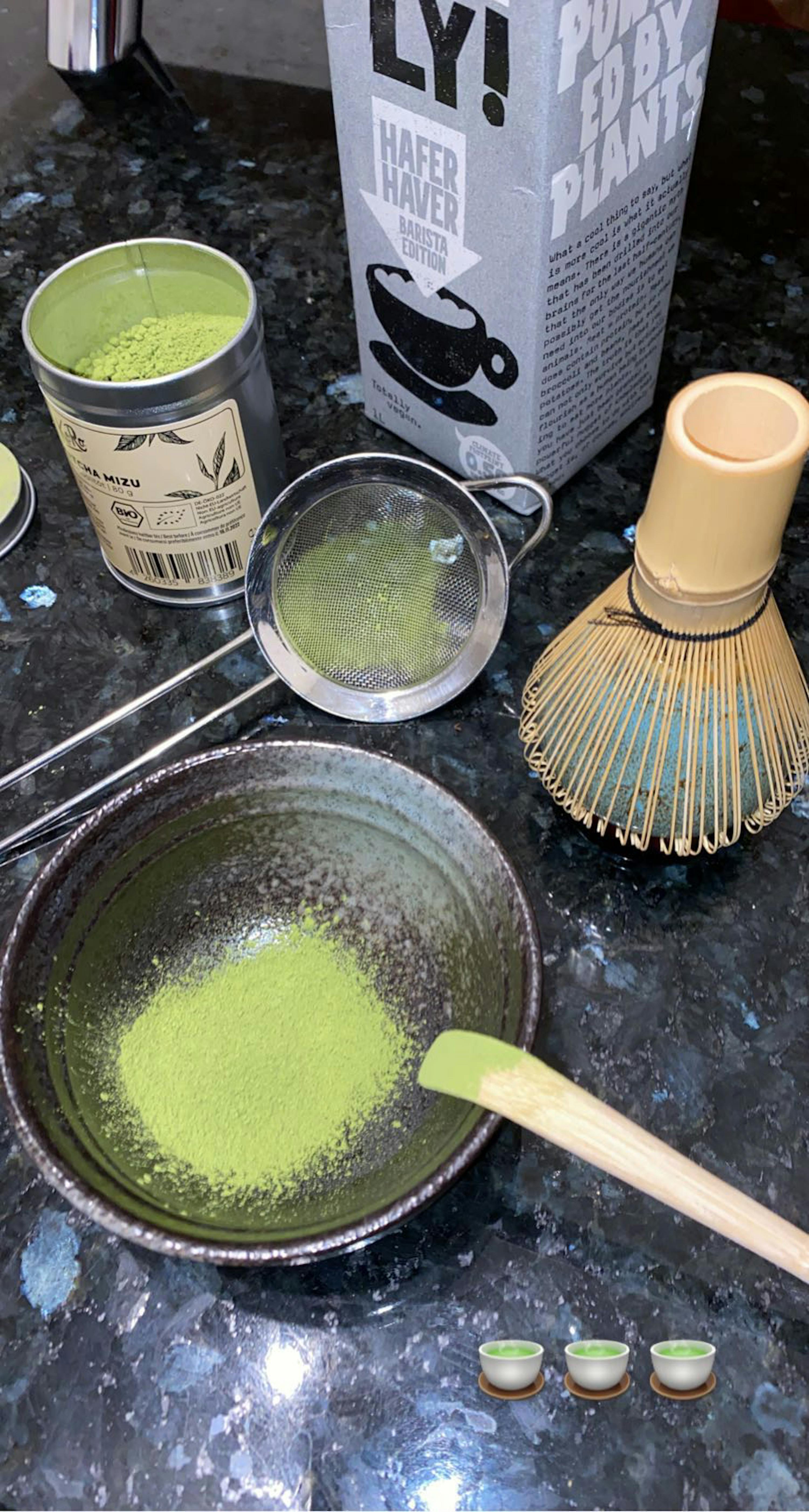 a bowl of green powder next to a box that says ly