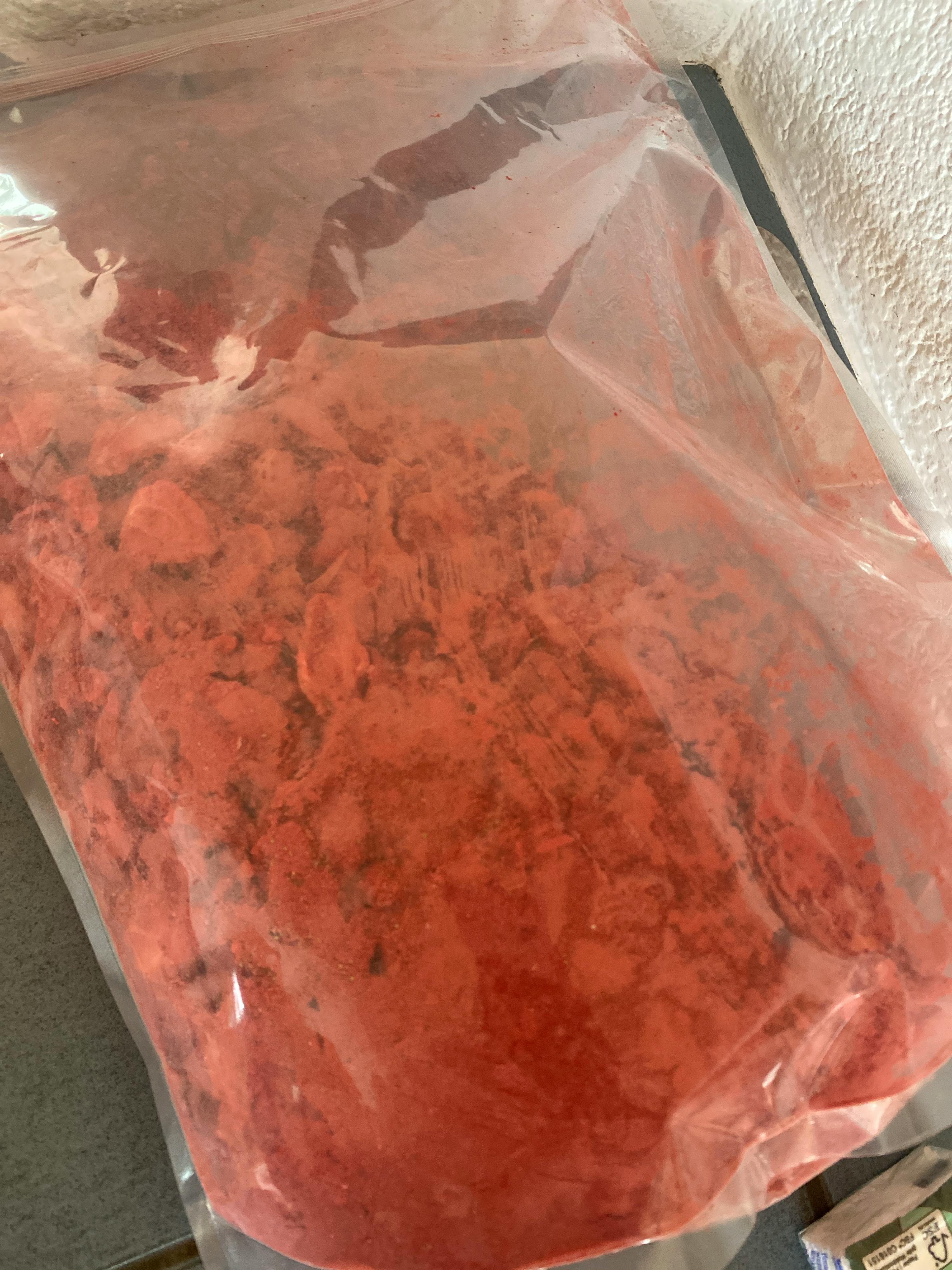 a bag of red powder has a label that says ' recycling ' on it