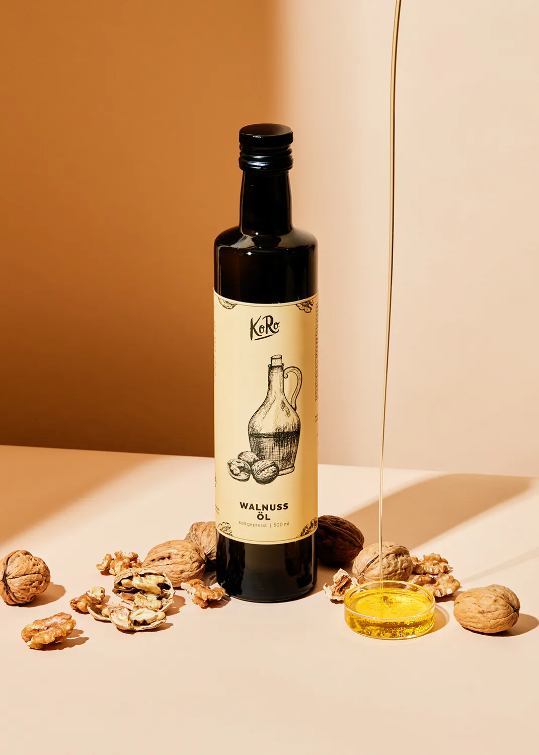 a bottle of walnut oil with nuts around it
