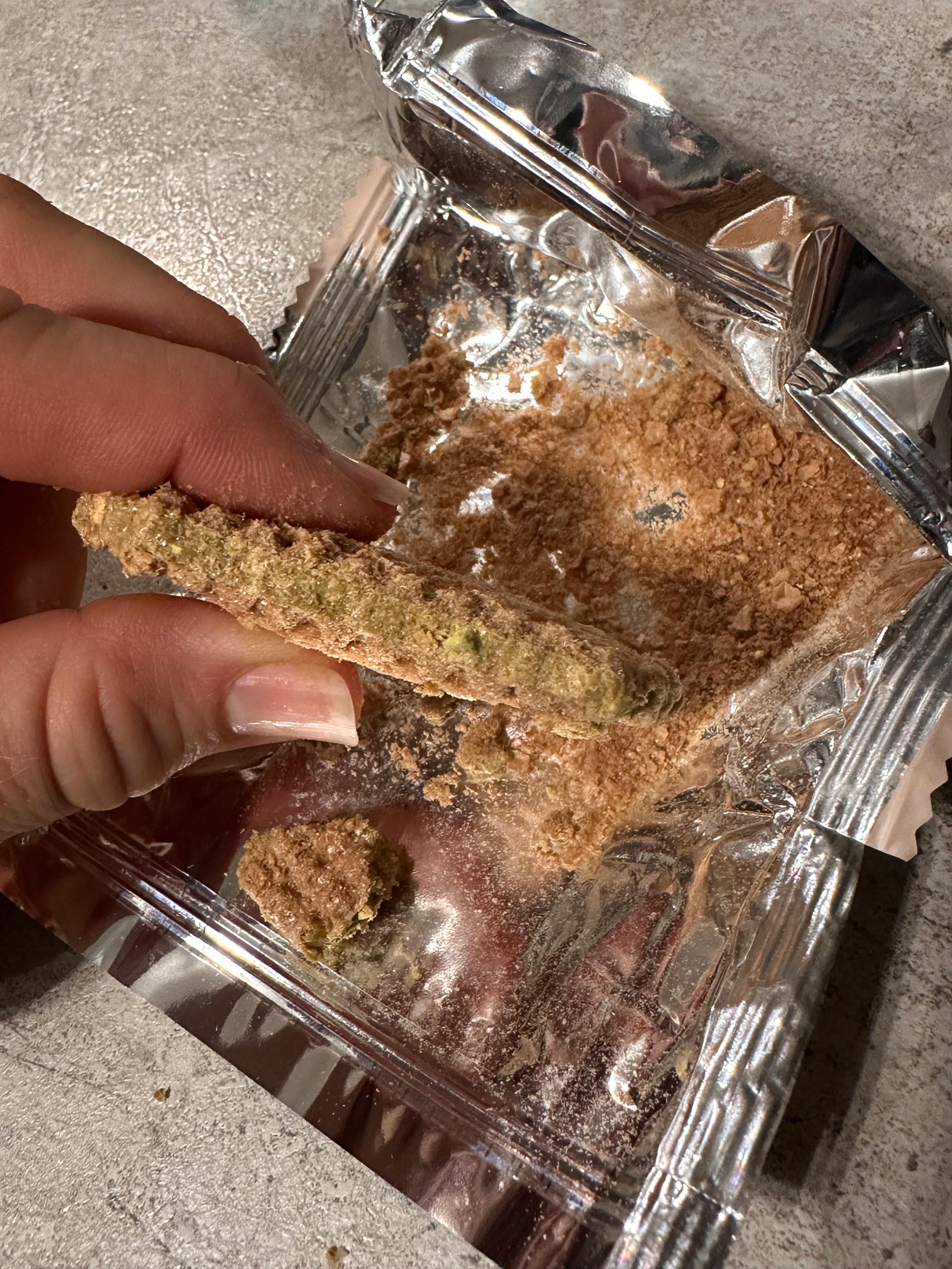 a close up of a person holding a piece of food