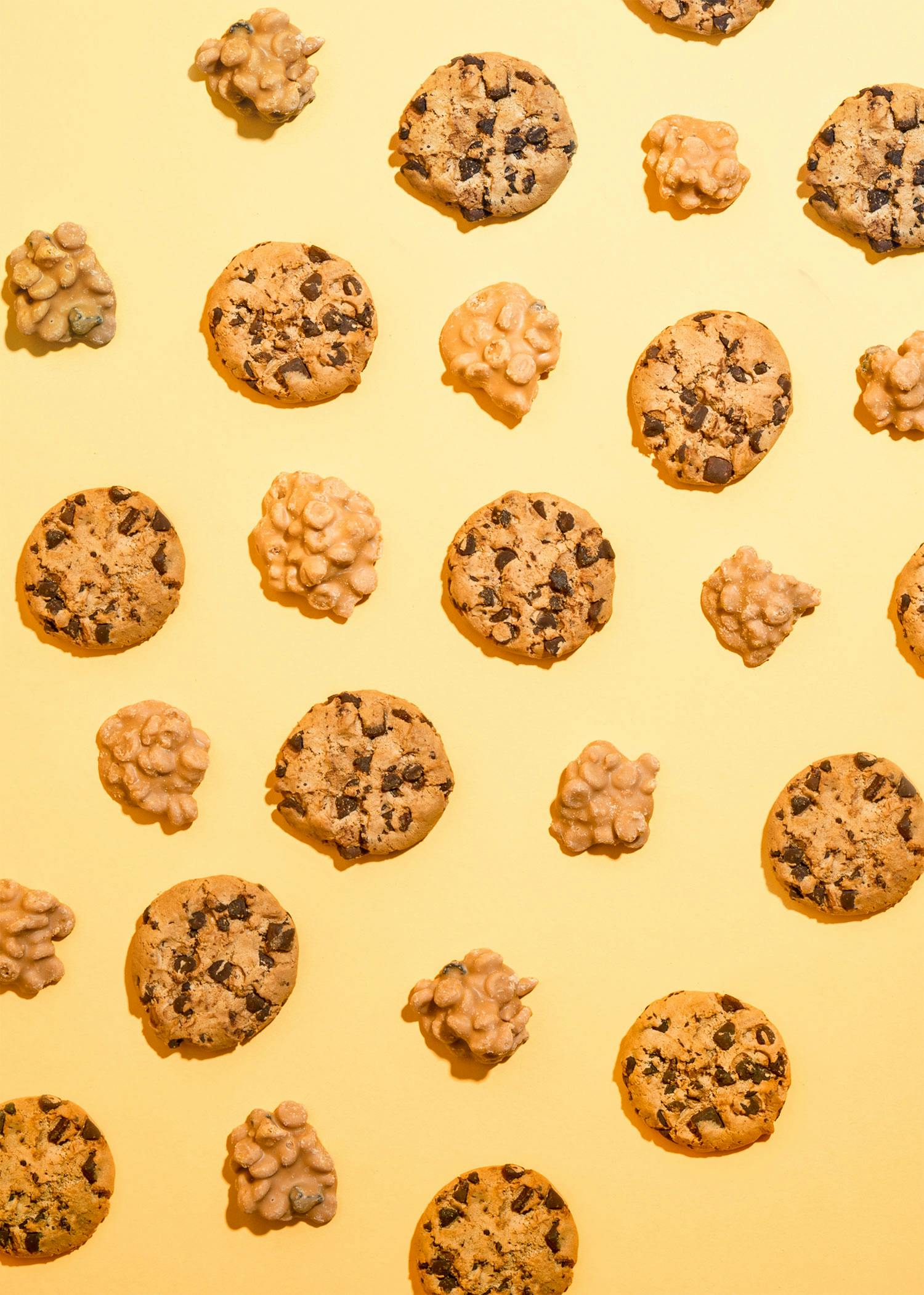 many different types of cookies on a yellow background