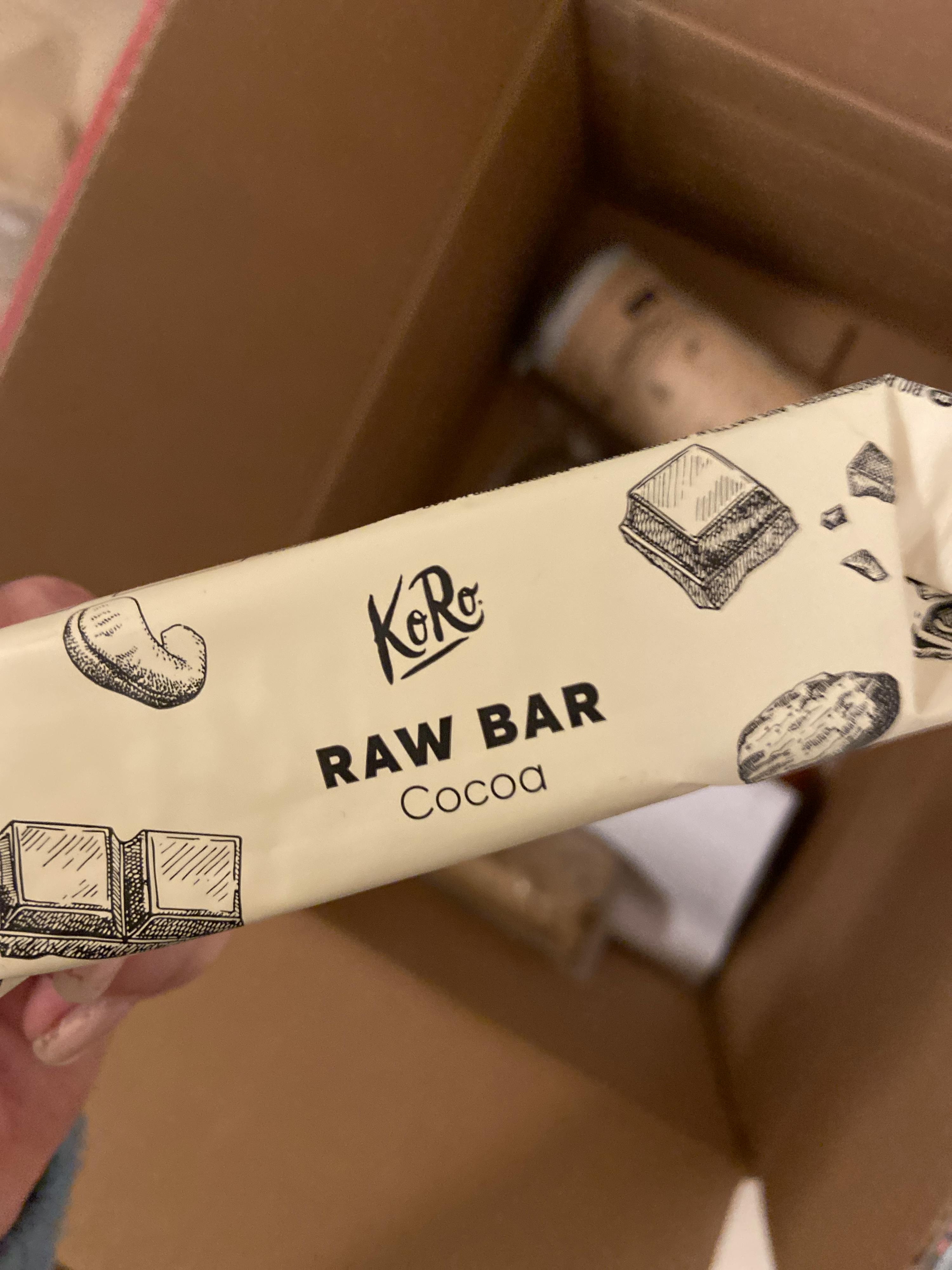 a person is holding a bar of raw bar cocoa