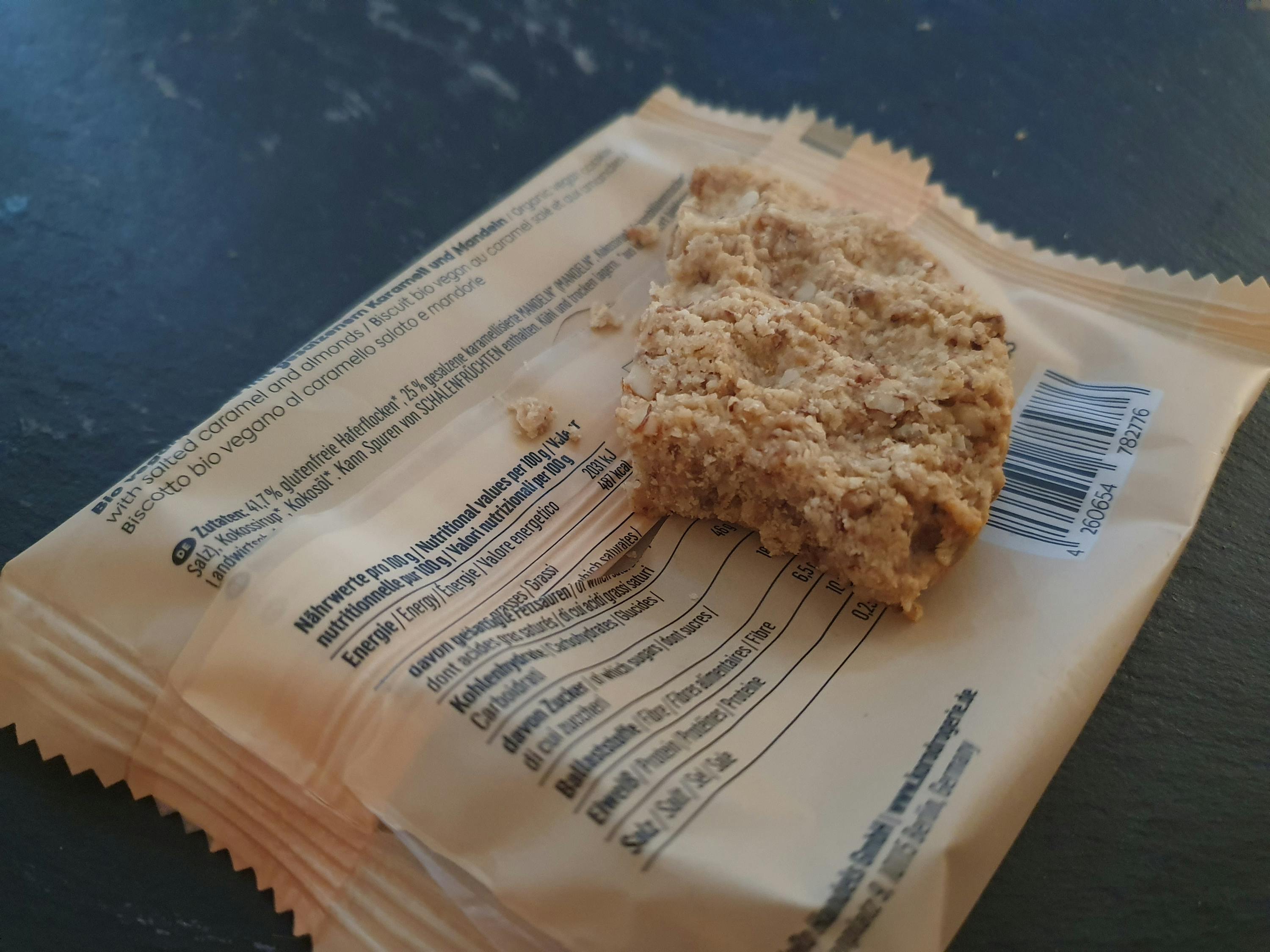 a close up of a package of granola bar with a bite taken out of it