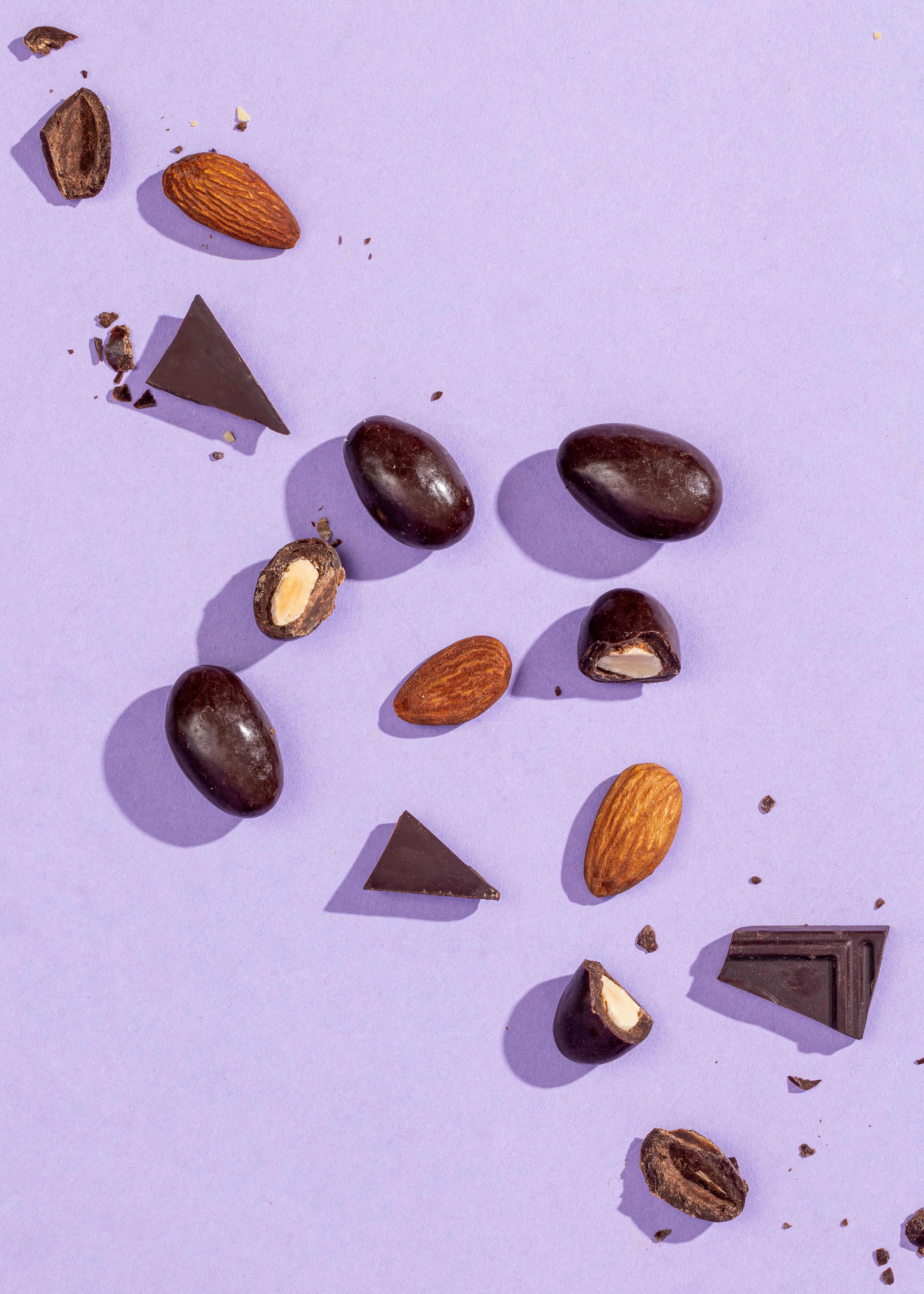 des amandes et des morceaux de chocolat sur fond violet