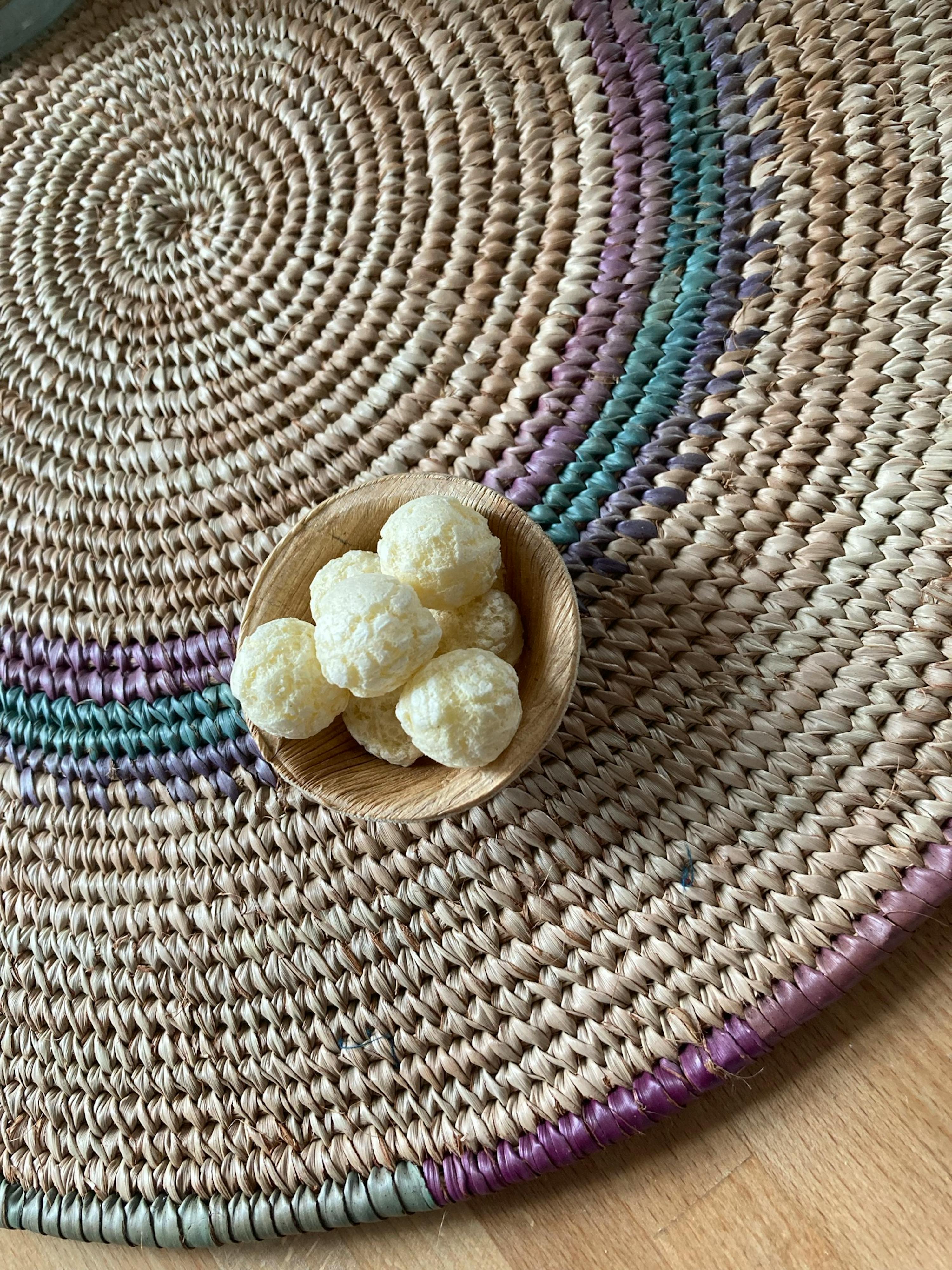 a wicker place mat with a small bowl of food on it