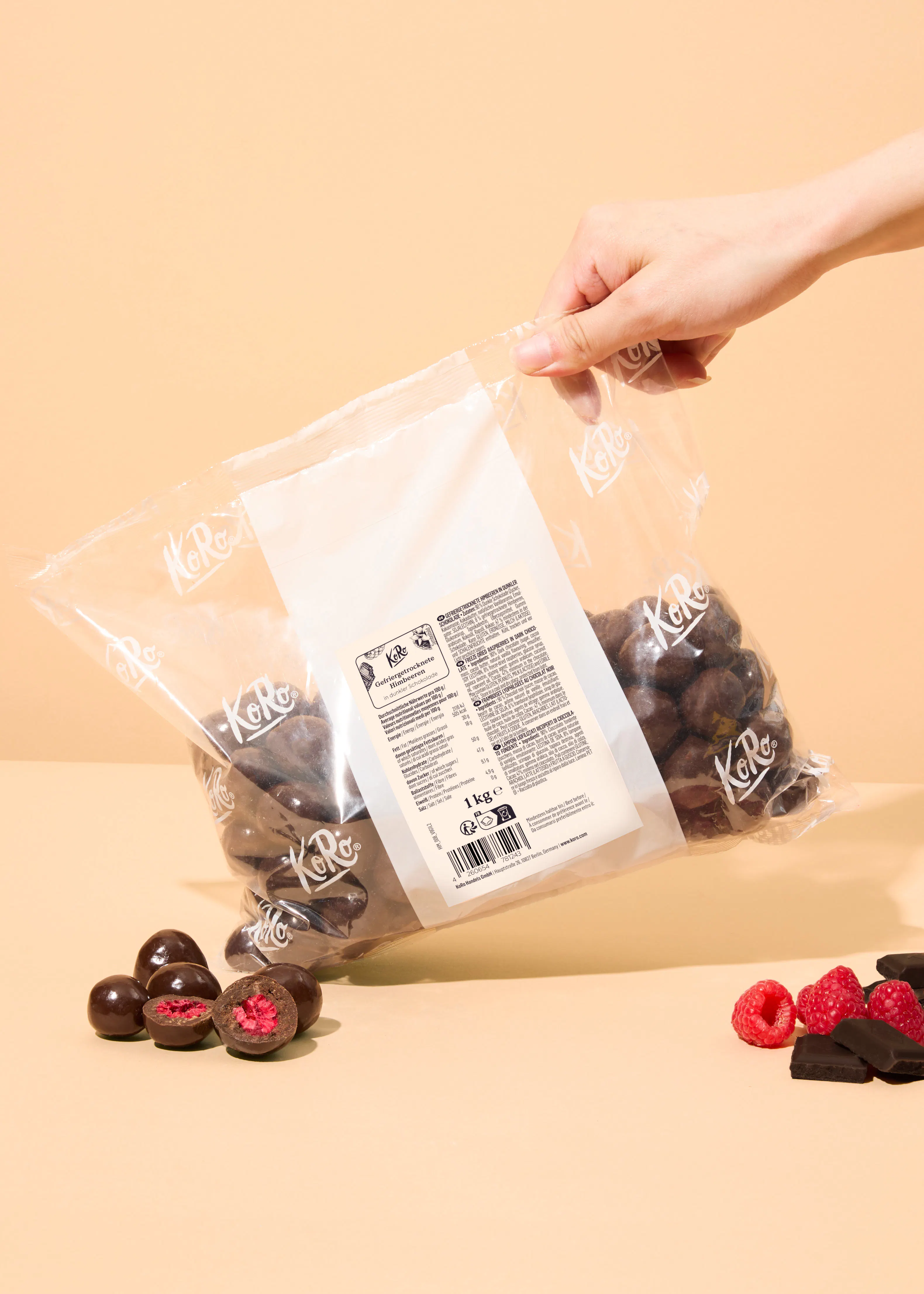 a person is opening a bag of chocolate covered raspberries