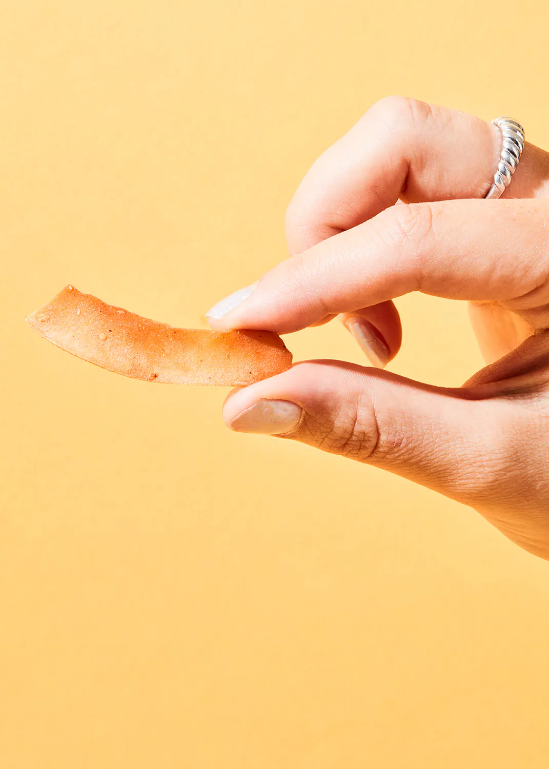 a person is holding a piece of food in their hand