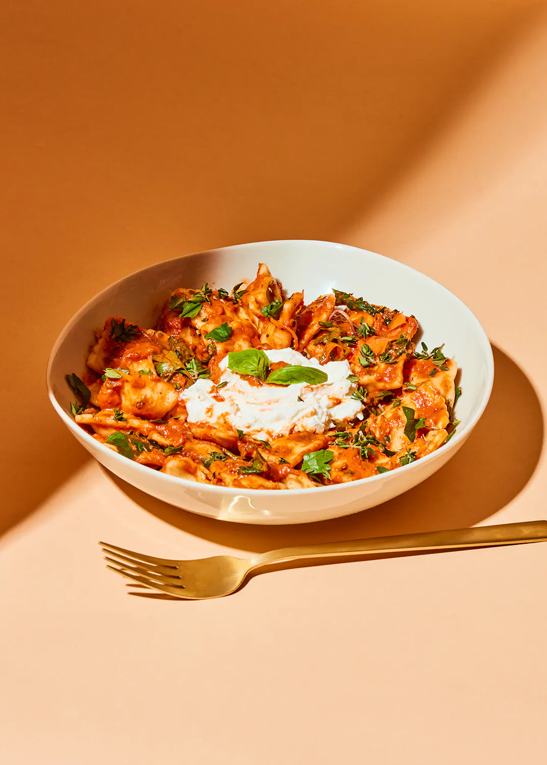 a plate of food with a gold fork next to it
