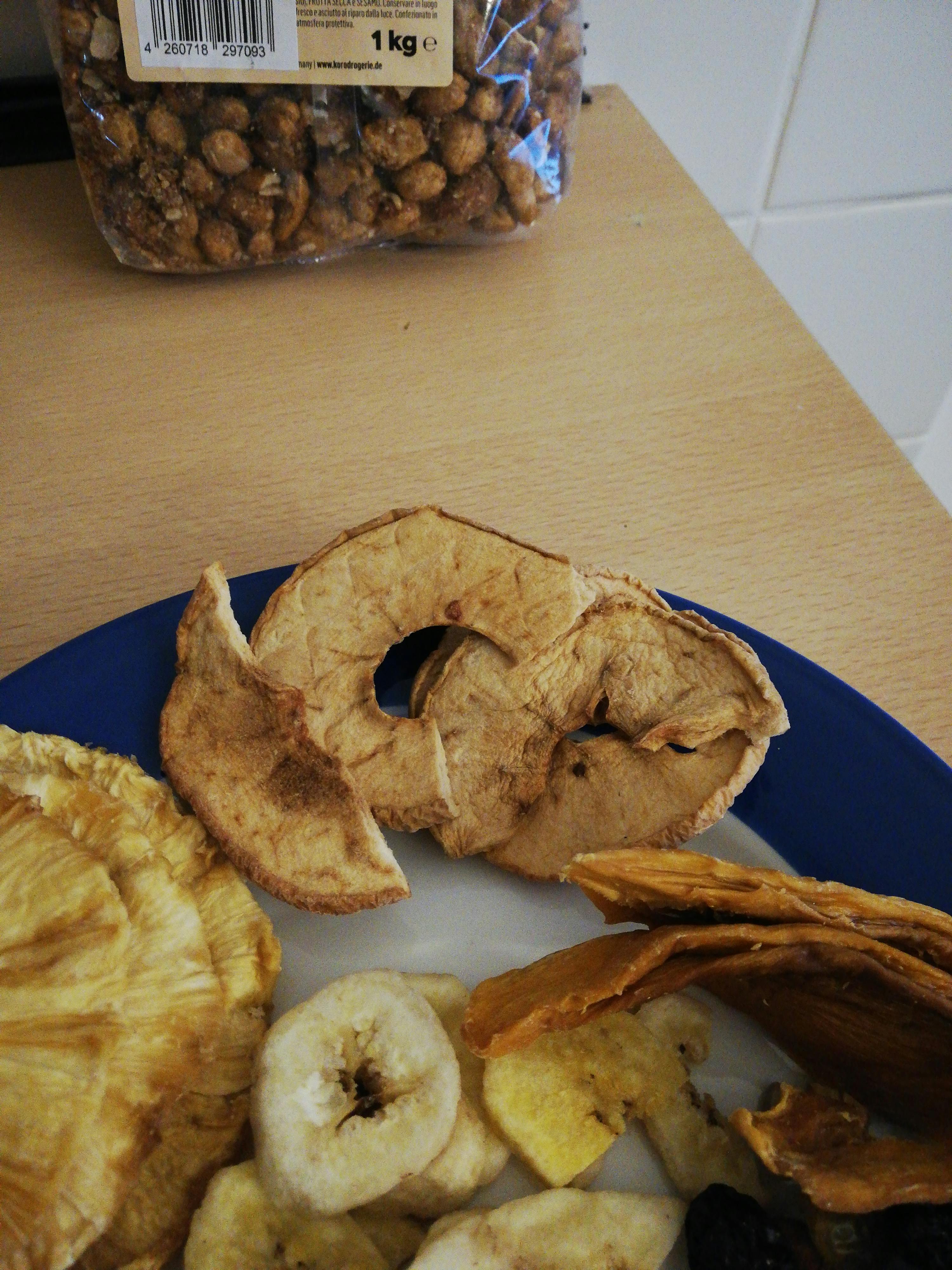 a blue plate with dried fruit and nuts on it