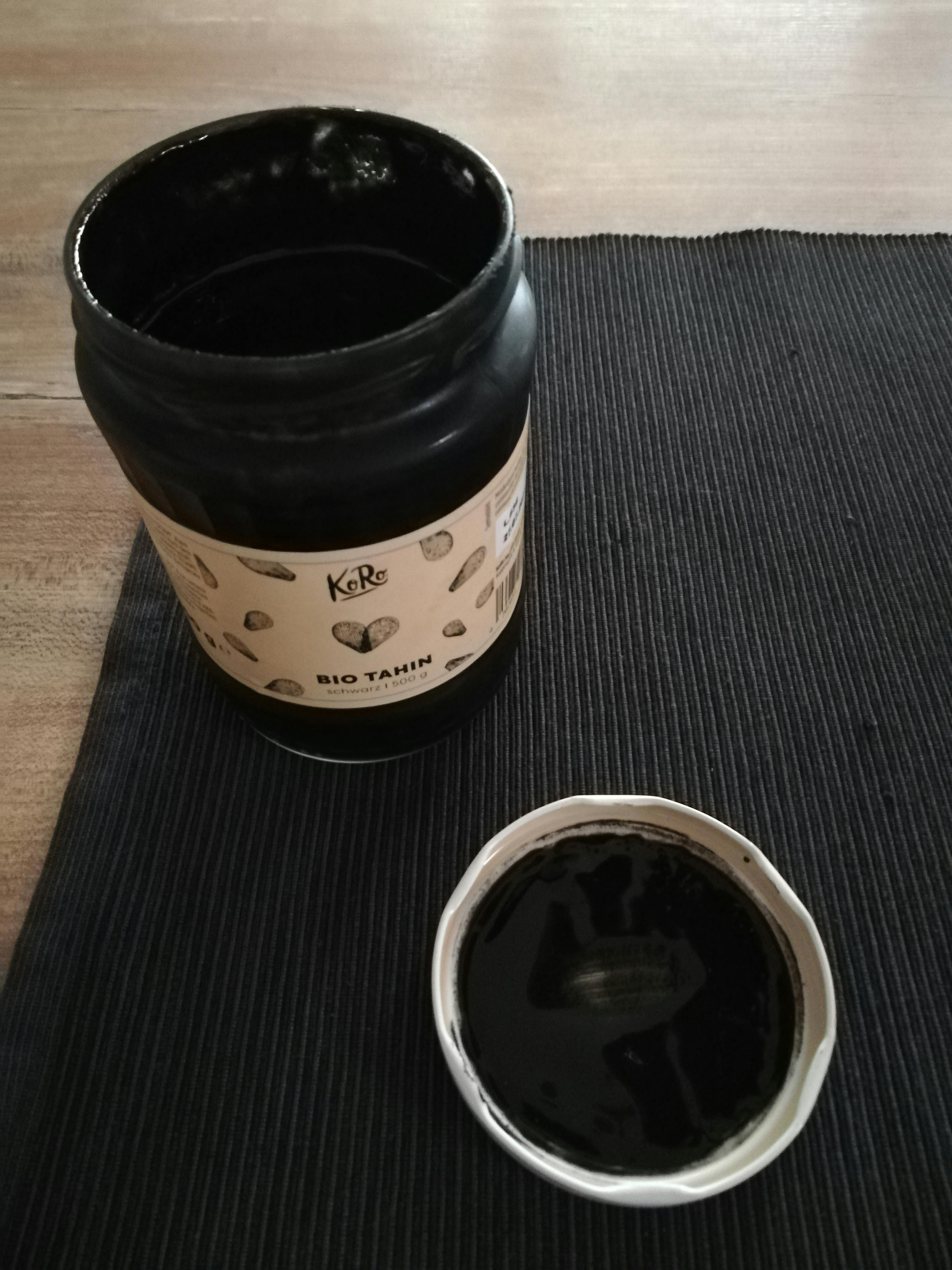 a jar of bio tahin next to a bowl of it