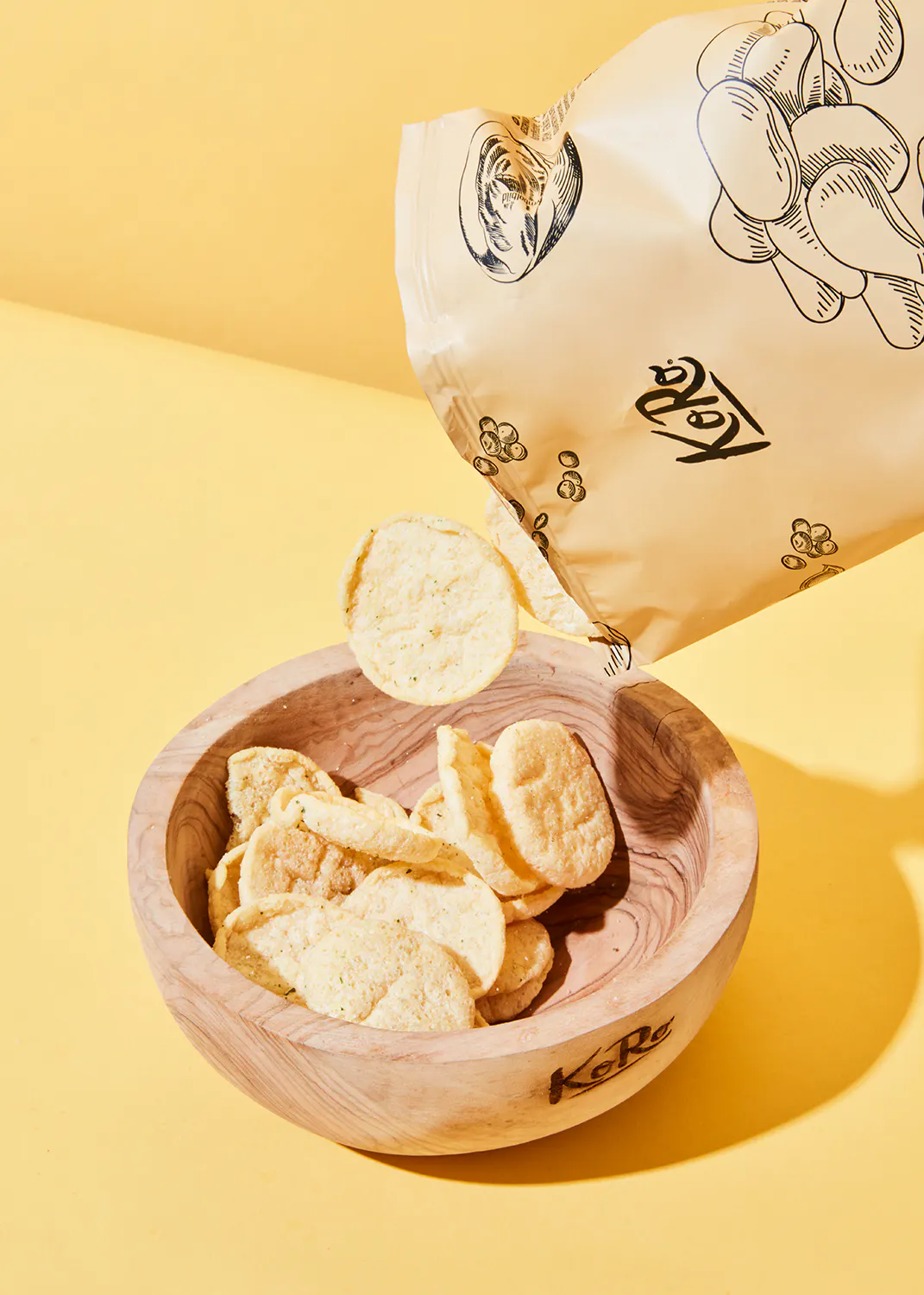 a bag of potato chips is being poured into a bowl