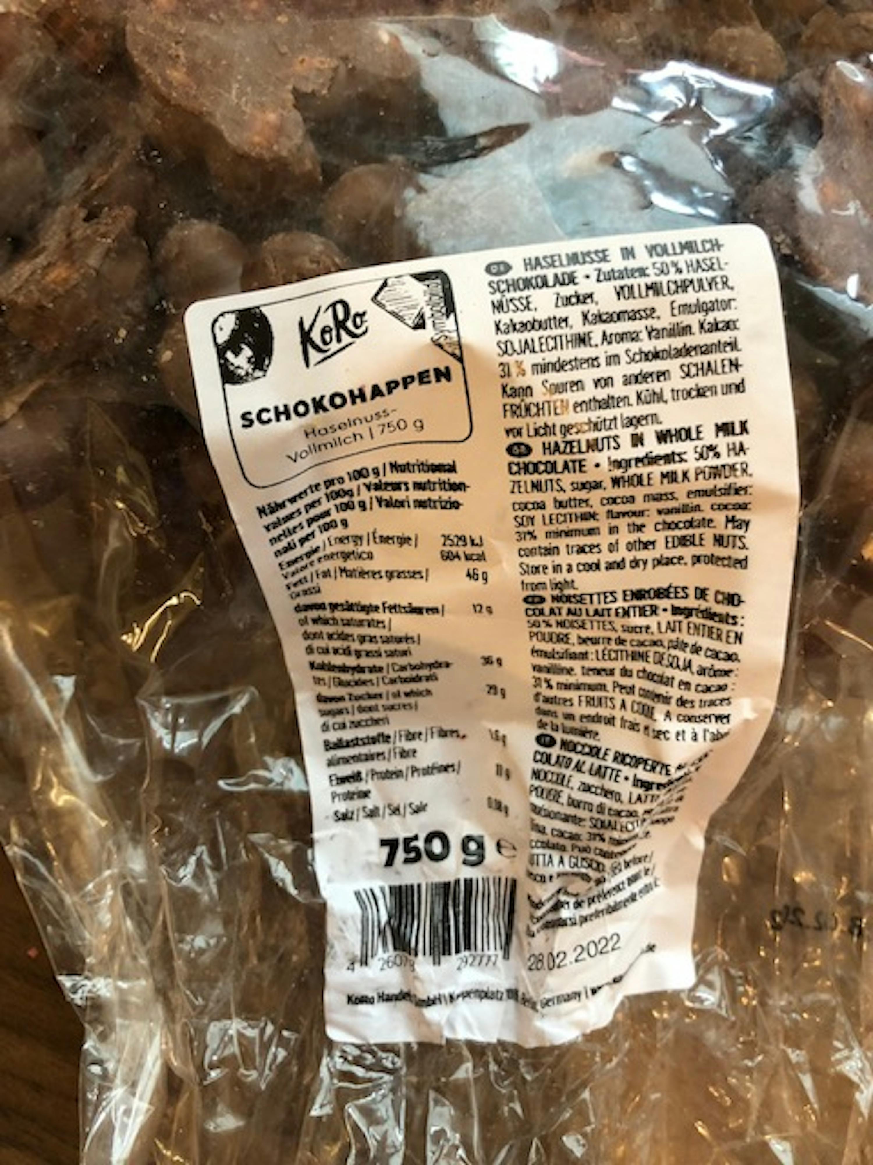 a bag of chocolate covered nuts has a label that says scho happen